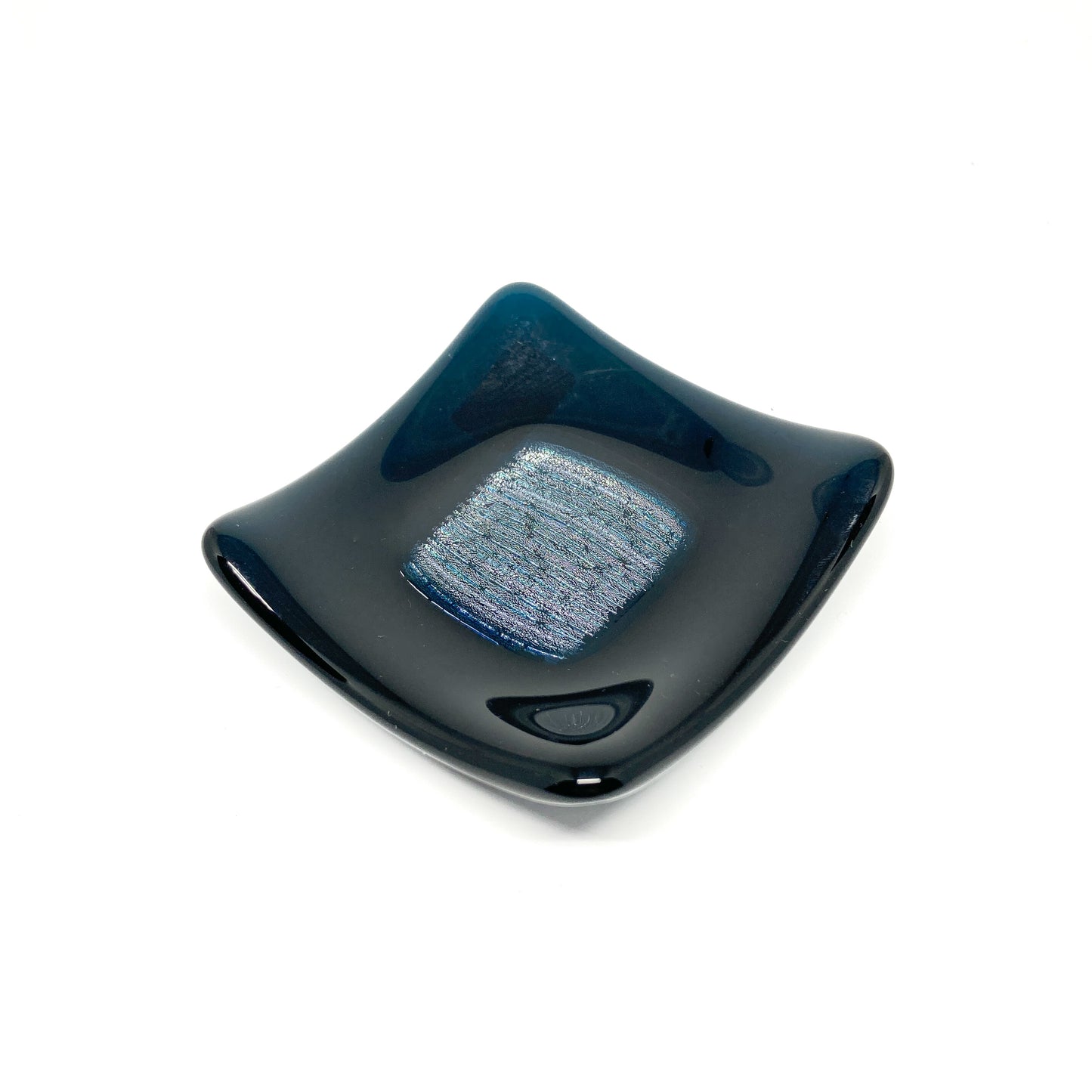 Dark blue dichroic glass bowl with a textured, reflective square center.
