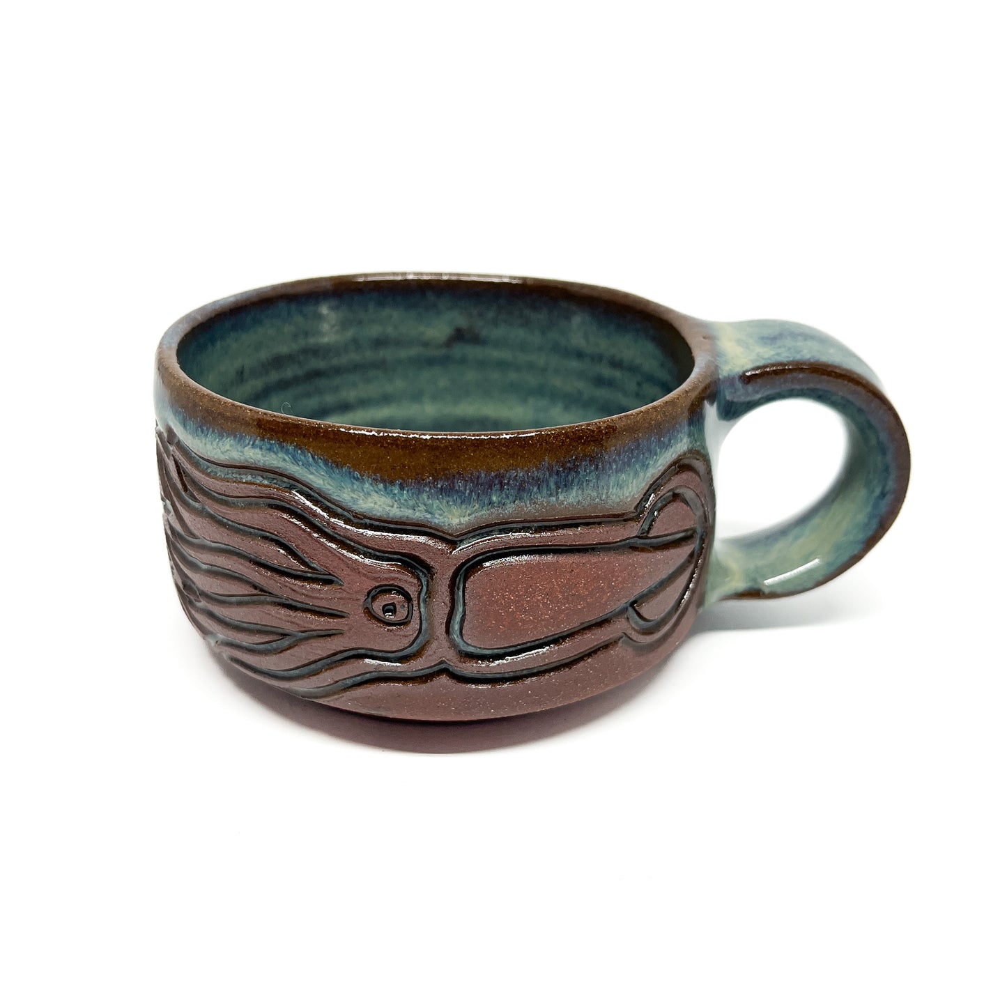 Handcrafted ceramic mug featuring a raised squid design with a smooth, glossy finish.