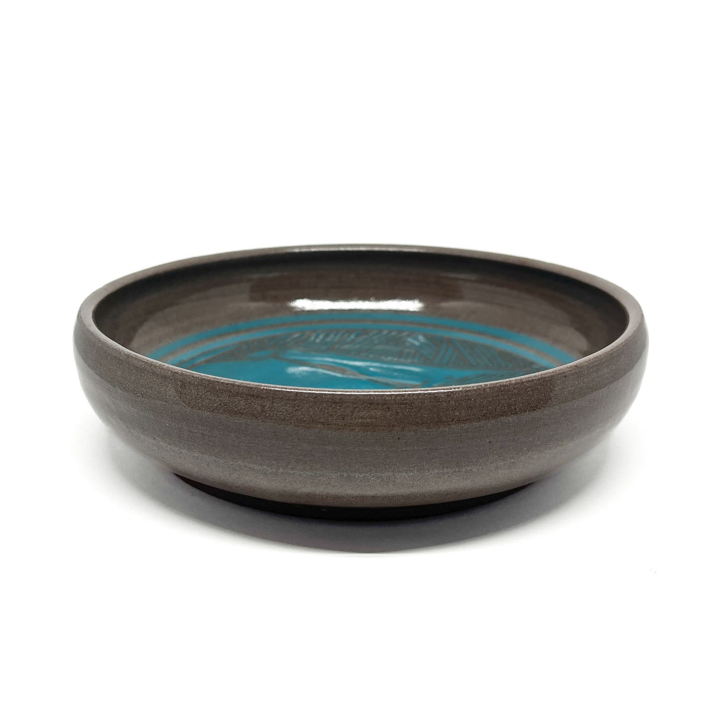 A blue ceramic bowl with a horizontal stripe design.