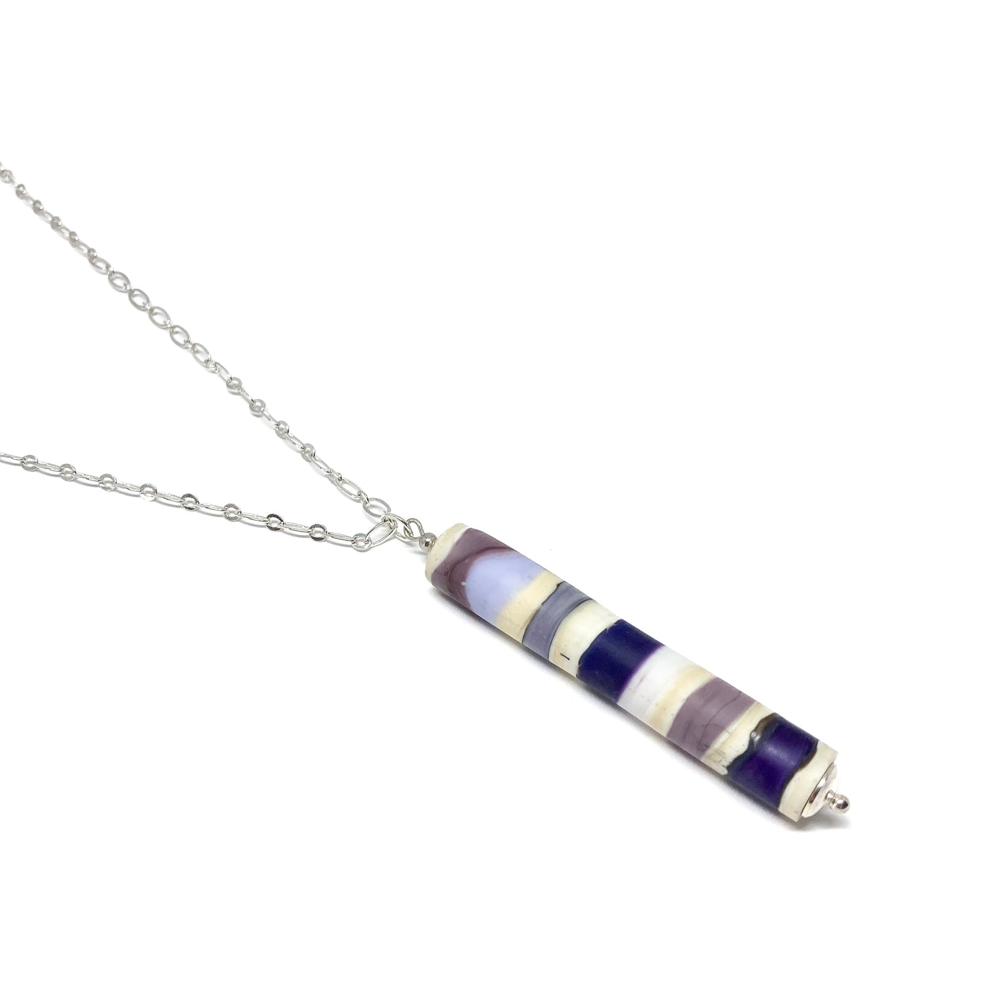 Silver chain necklace with a cylindrical pendant featuring purple, blue, and white stripes, and a small silver bead.