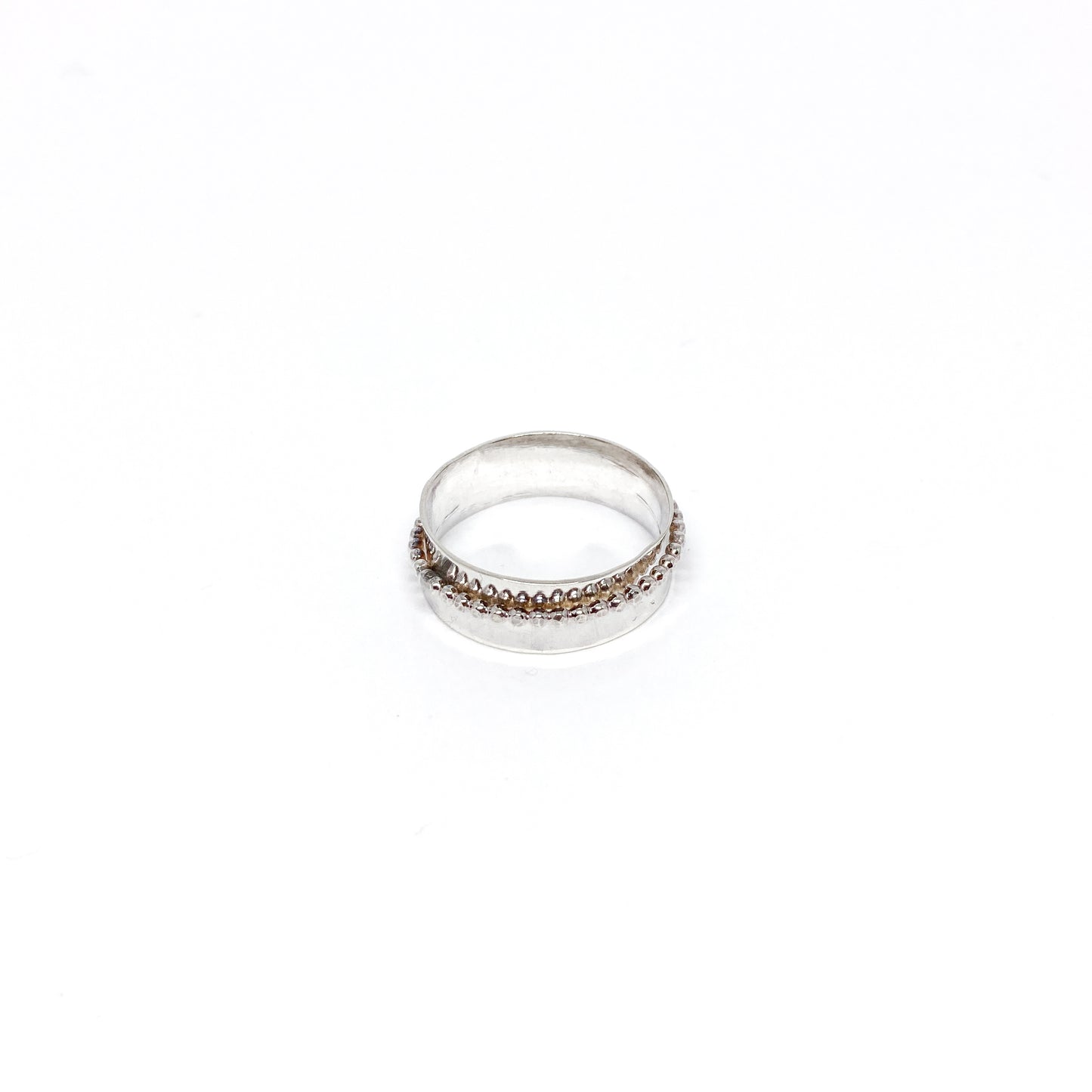 Handmade hammered sterling silver spinner ring with a beaded spinning band.