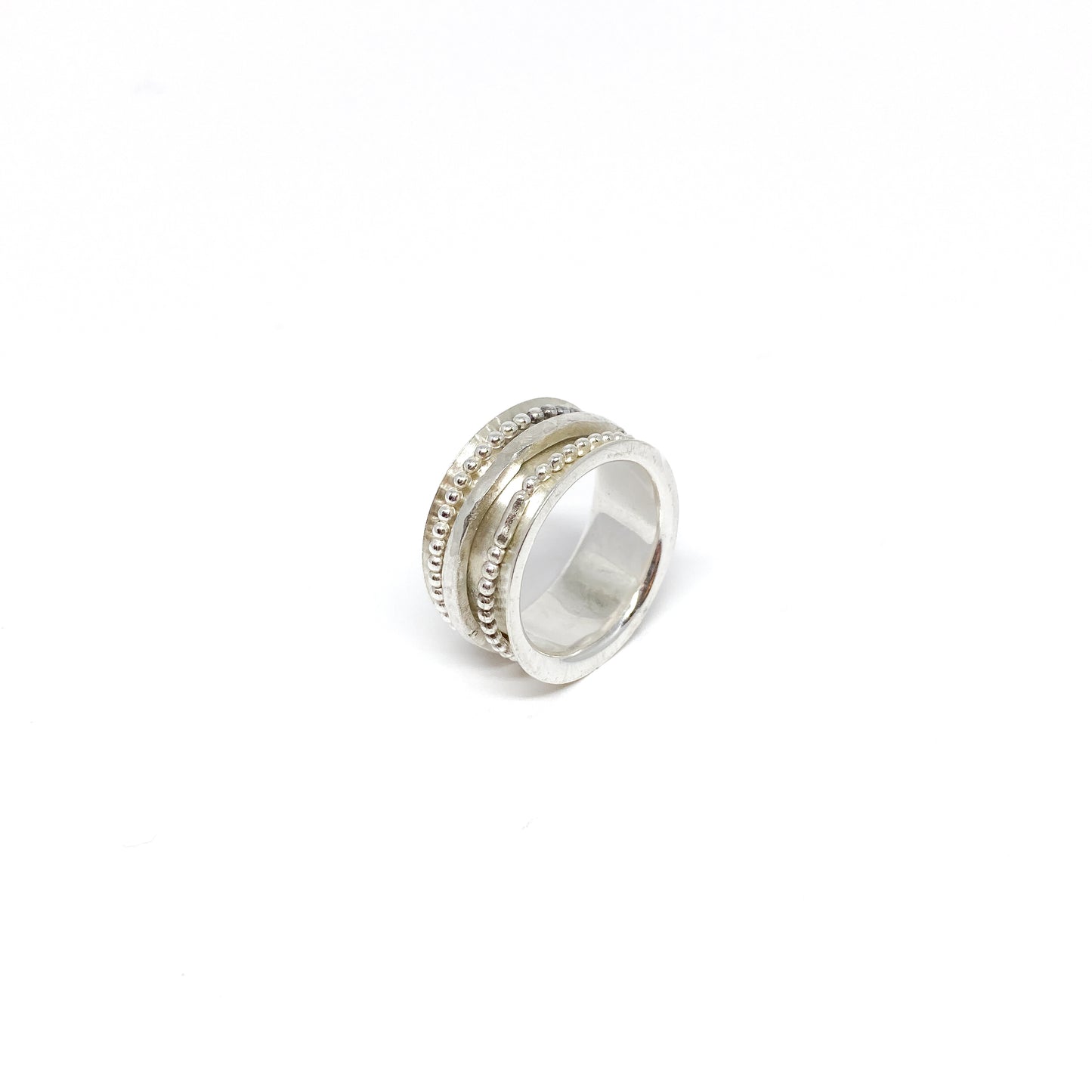 Sterling silver spinner ring with multiple textured and beaded spinning bands.