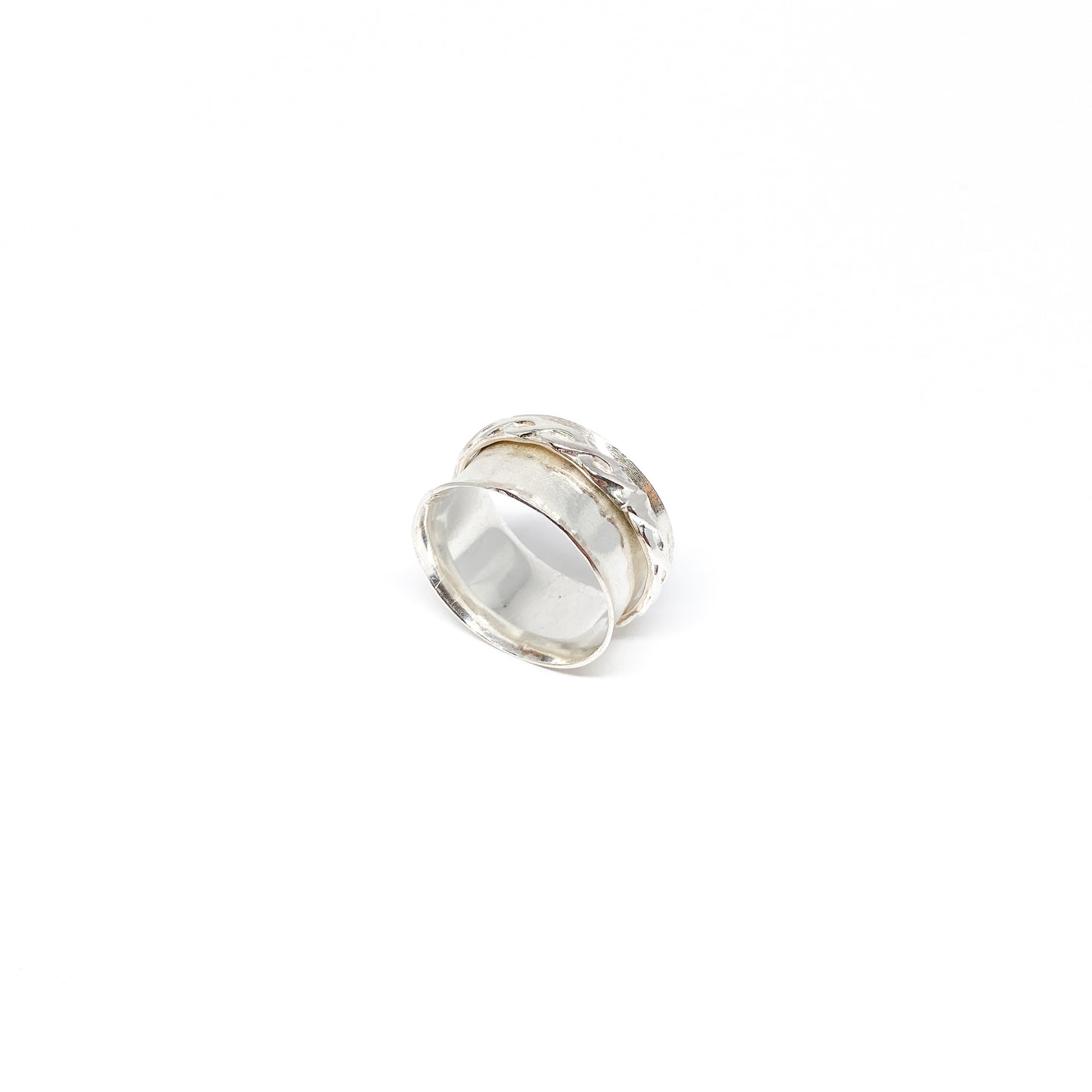 Hammered sterling silver spinner ring with a textured, movable outer band.