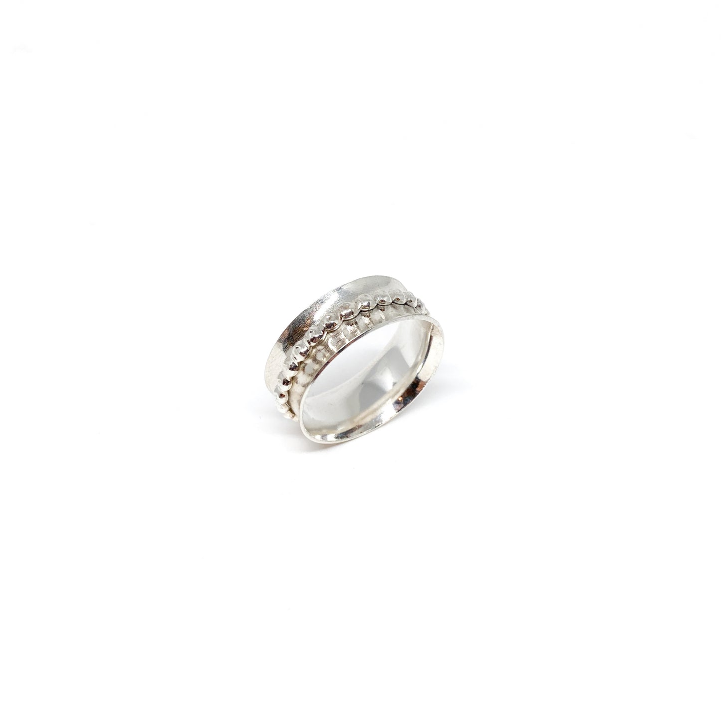Silver spinner ring with a textured spinning band featuring rows of small dots.