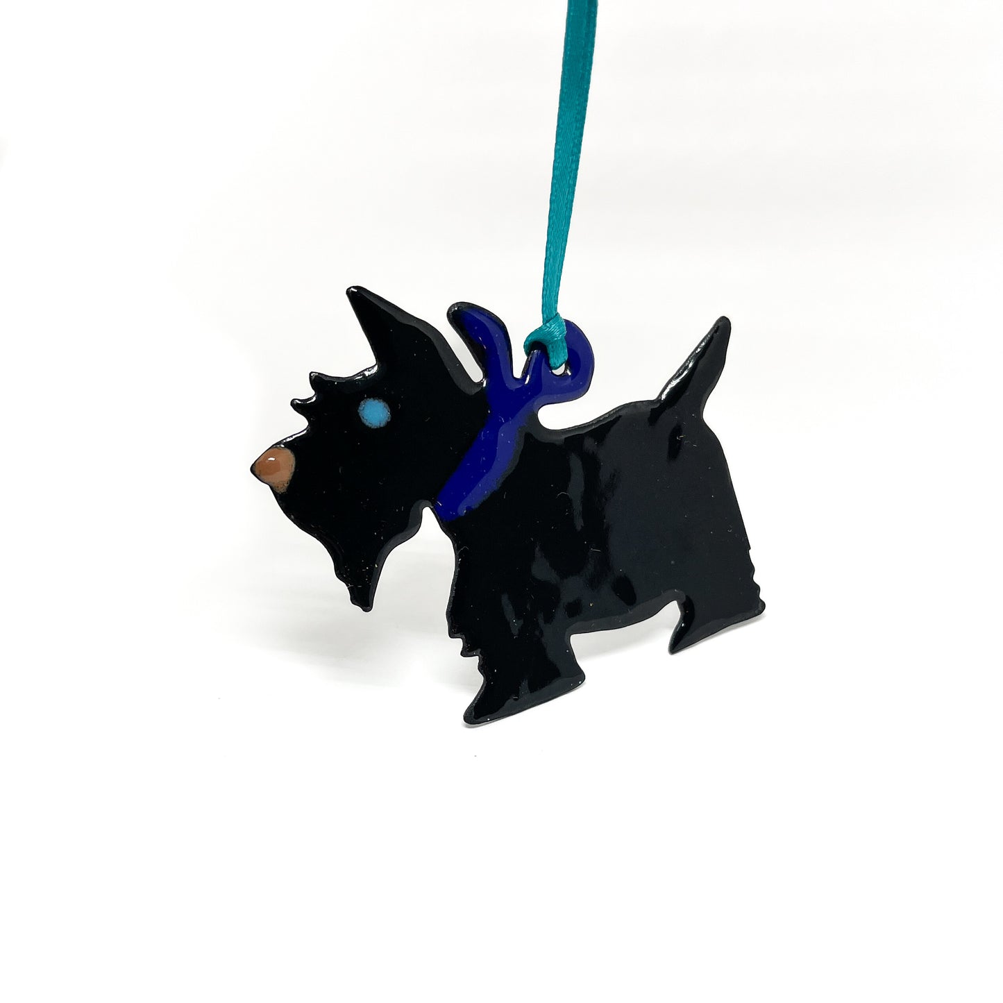 Black Scottie dog ornament with a shiny finish, a blue collar, and a teal hanging ribbon.