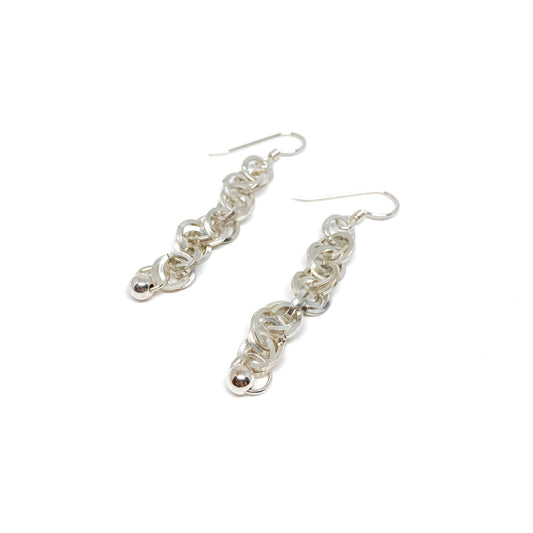Two silver square chain dangle earrings with a bead at the bottom, hanging from fishhook ear wires.