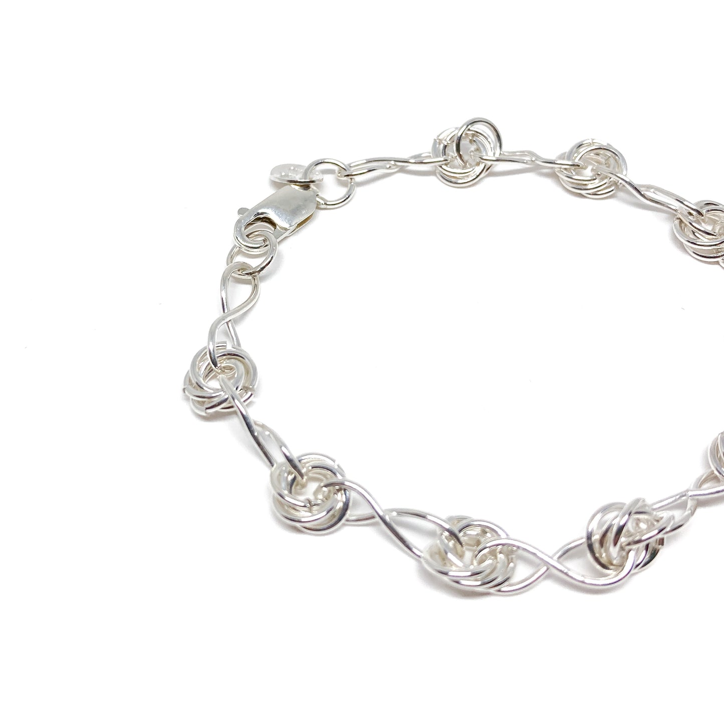 Infinity Knot Bracelet displayed with visible clasp and alternating twisted link design.