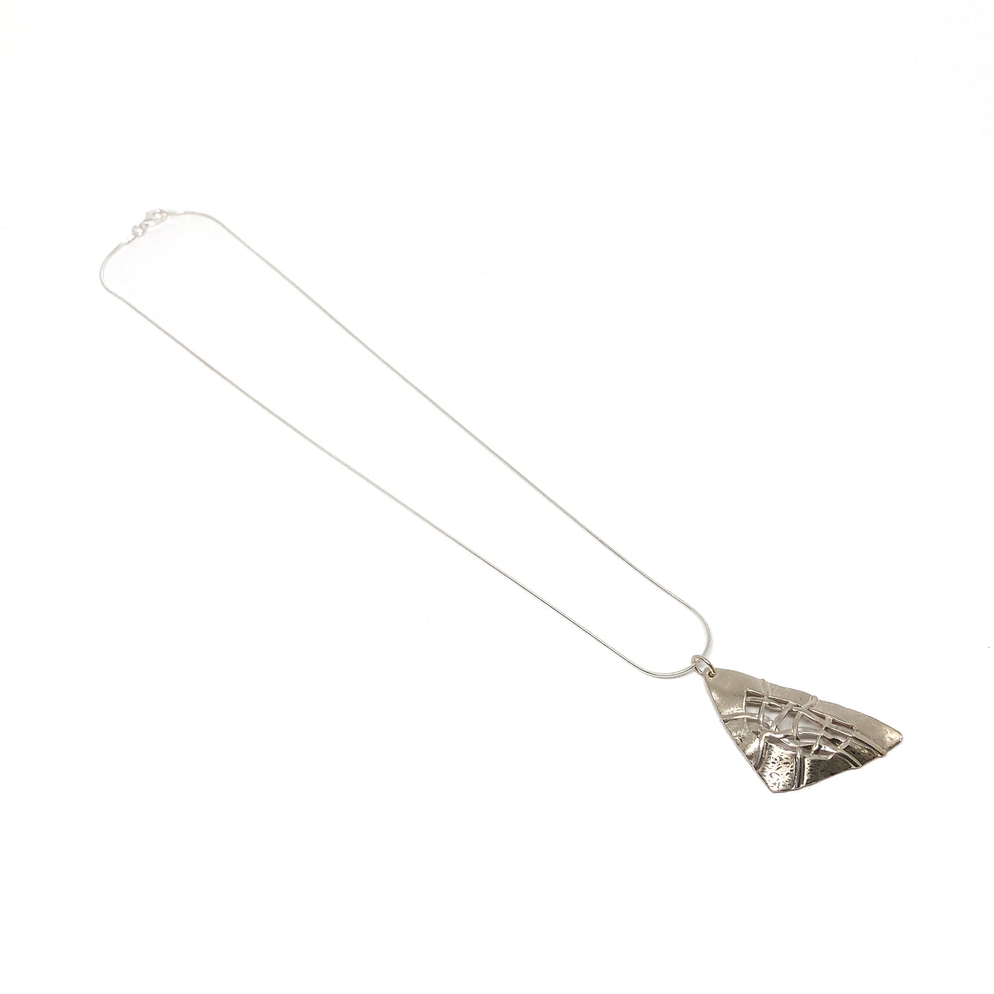 A silver pendant necklace with a triangular design and woven silver details. The pendant hangs from a delicate silver chain.