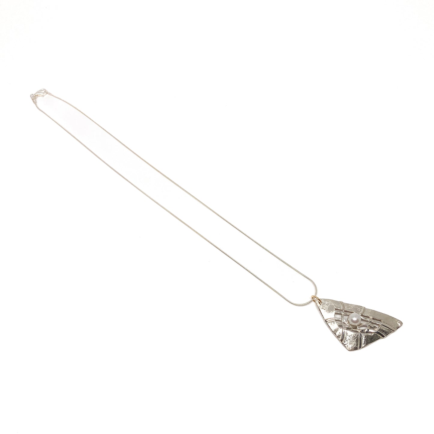 A silver pendant necklace with a triangular design, woven silver details, and a pearl accent. The pendant hangs from a delicate silver chain.