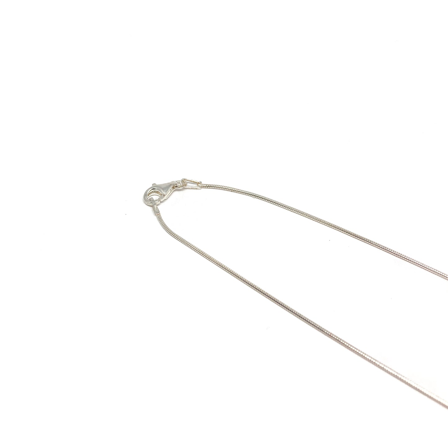 A close-up of a silver necklace clasp and chain. The delicate chain is thin and reflective.