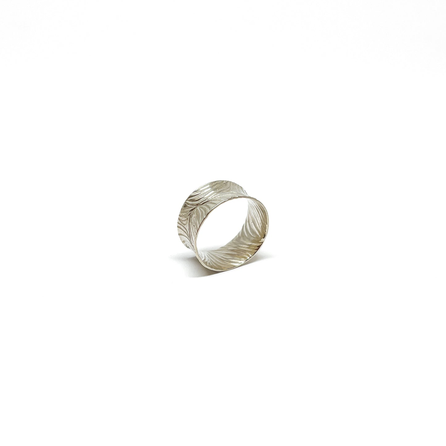 Textured sterling silver cuff ring with a wide band and an etched, flowing abstract design.
