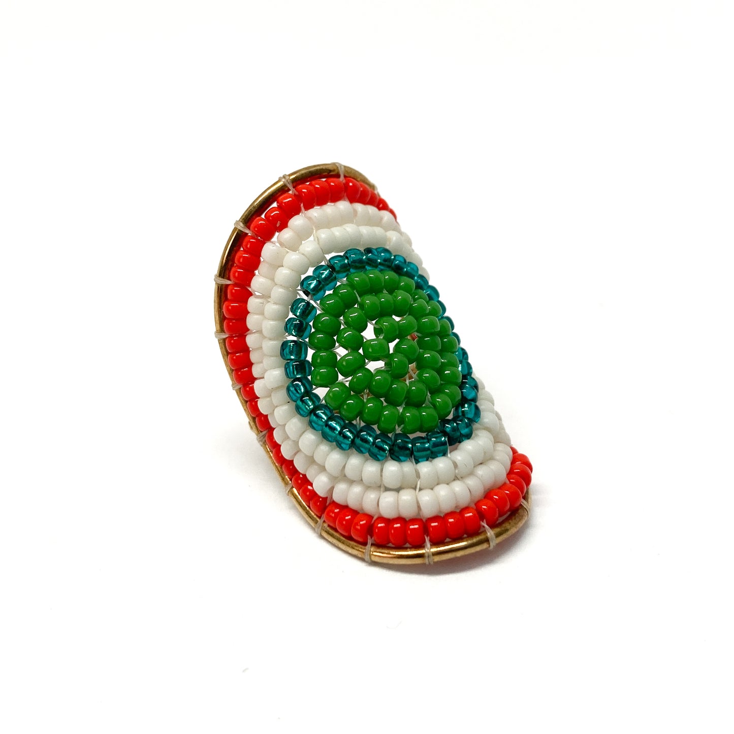 A gold ring features a vibrant, textured design of concentric beaded arcs in green, teal, white, and red.
