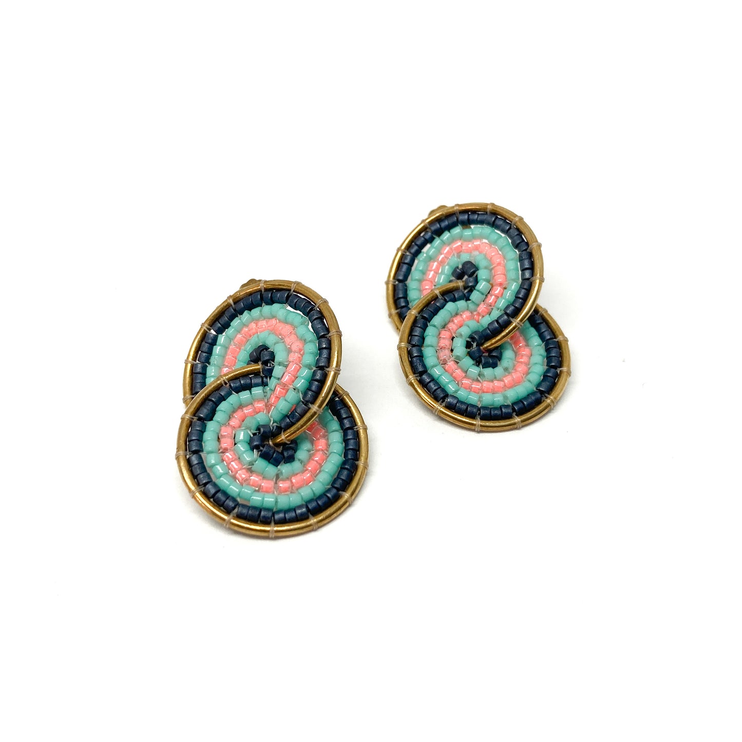 Two gold-toned clip-on earrings feature a figure-eight design intricately filled with dark blue, teal, and pink beads.