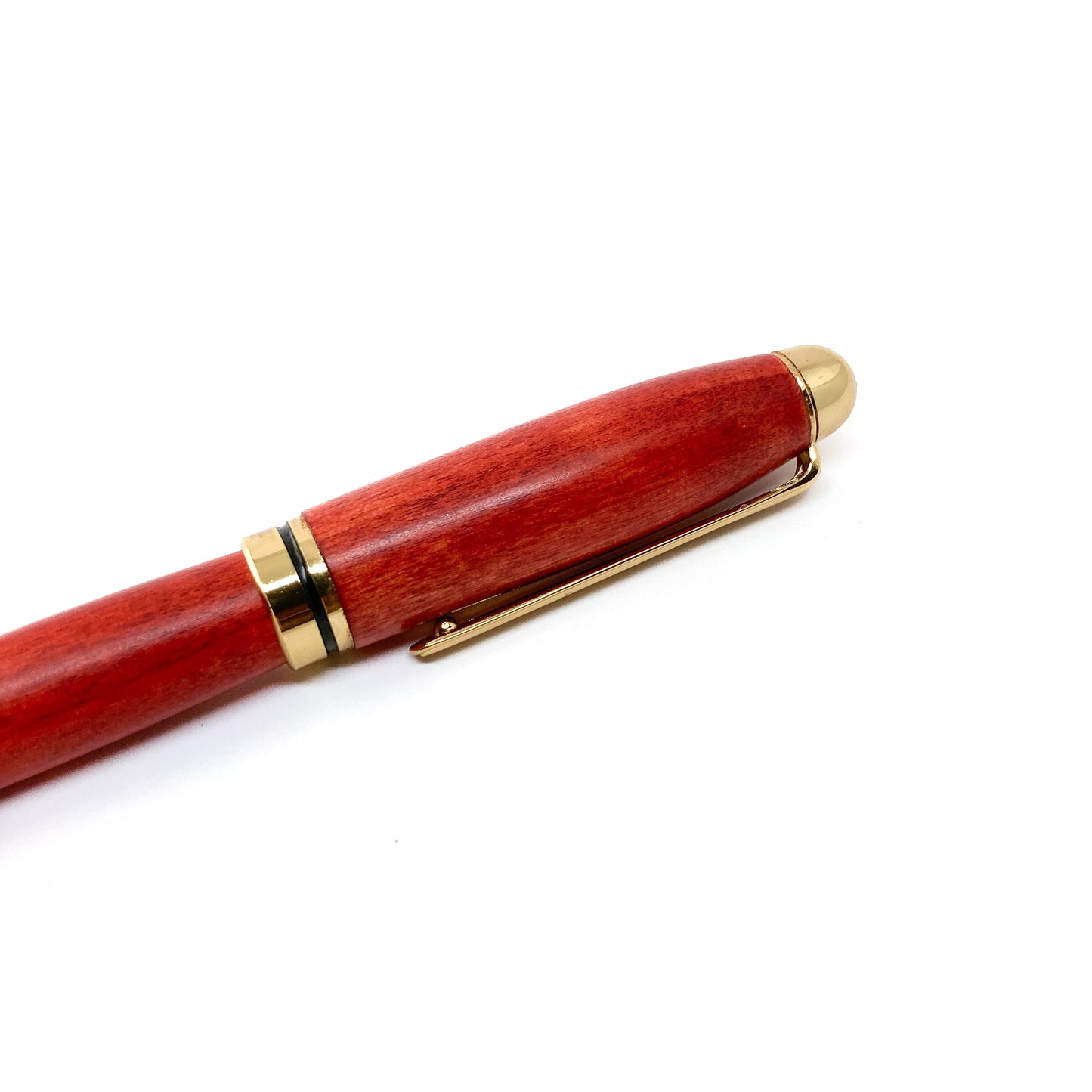 Red wood pen with gold trim and clip, close-up view.