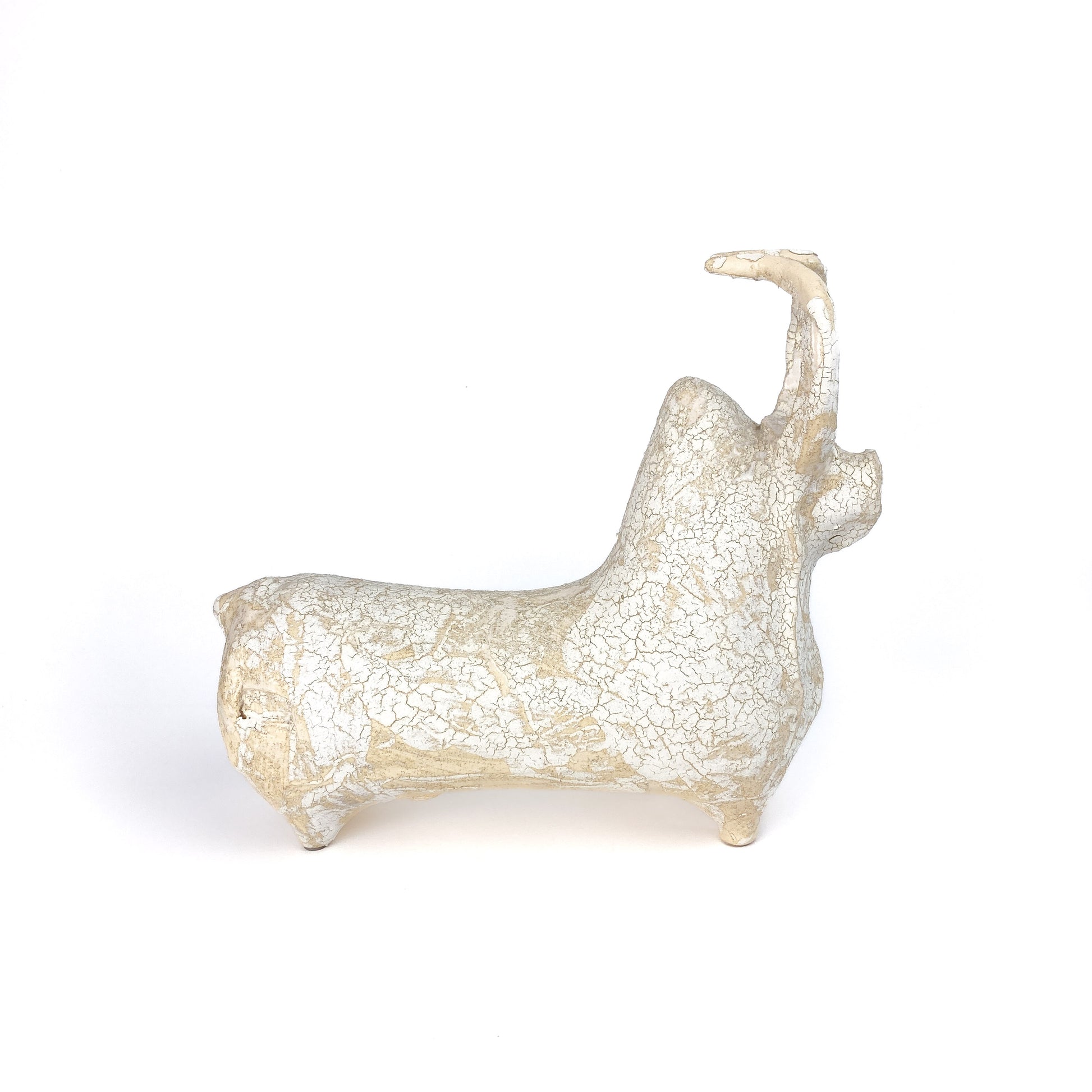 A textured, light-toned ceramic bull figurine with a raised head and tail, showing a crackled glaze finish.