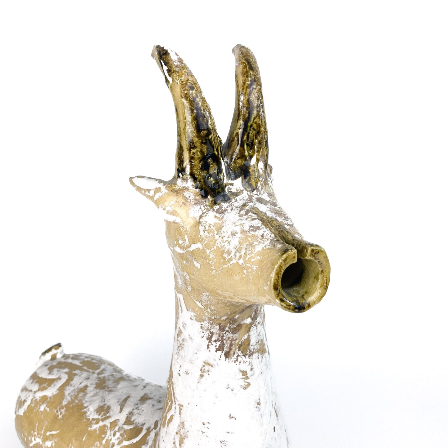Close-up of a textured ceramic Long Neck Bull head with tall, curved horns and a distressed, light-toned glaze with white accents.