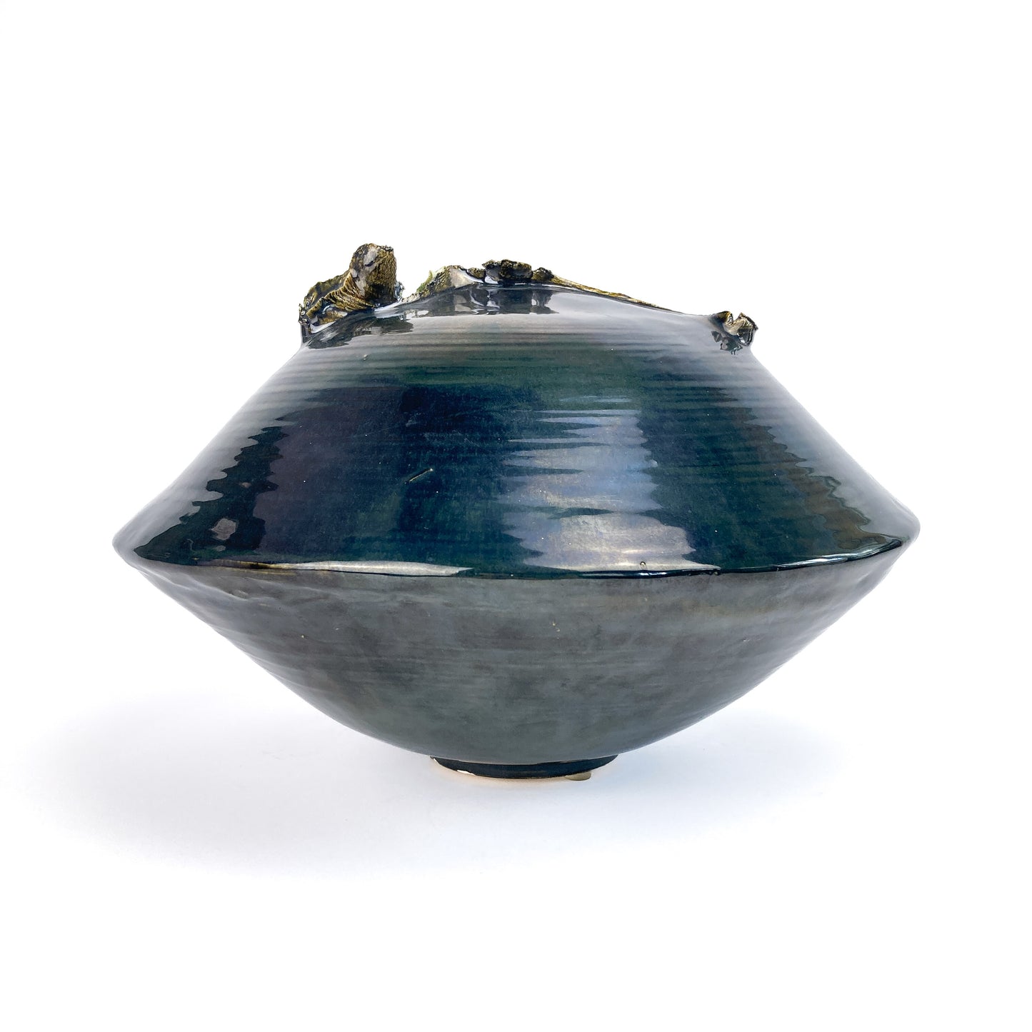 A dark, conical ceramic UFO sculpture with a textured, organic rim and a subtle gradient in its glaze.