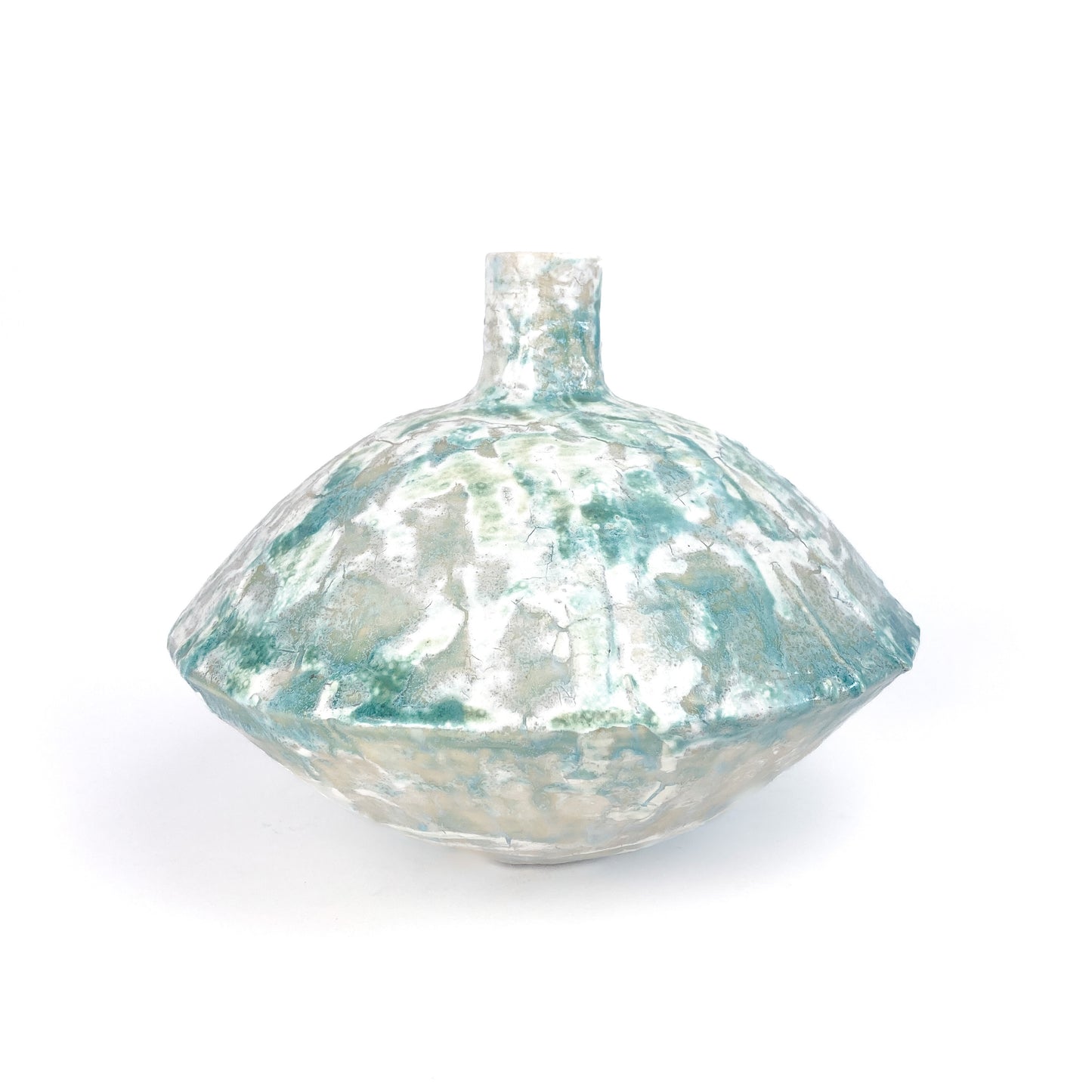 A textured ceramic UFO vessel with a narrow neck and a mottled teal and light beige crackled glaze.