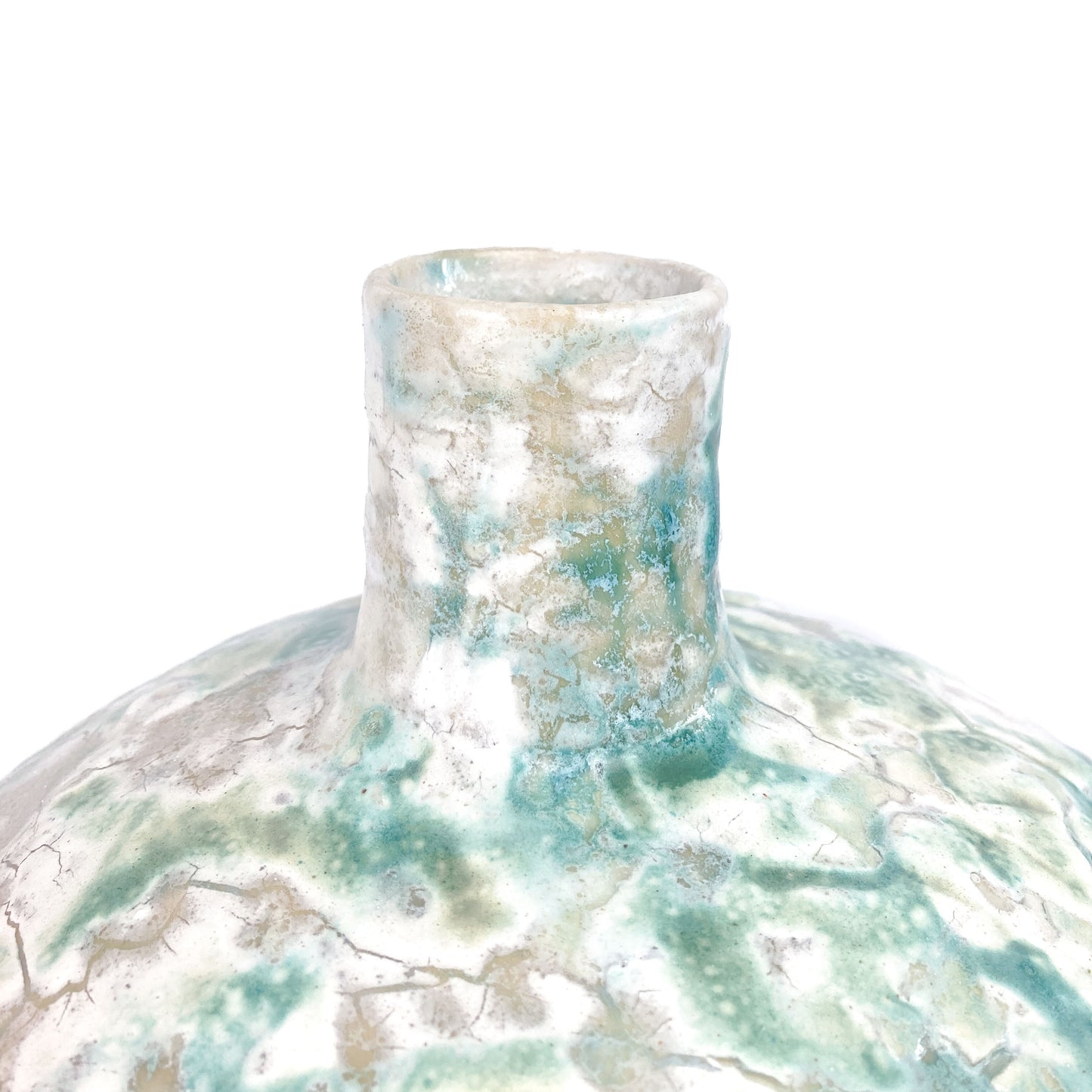 Close-up of the narrow neck of a textured ceramic UFO vessel with a mottled teal and light beige crackled glaze.