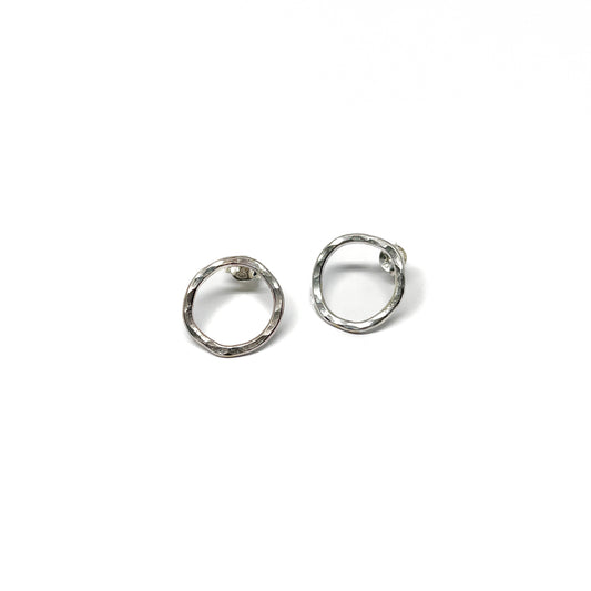 Hammered silver loop earrings, one angled view.