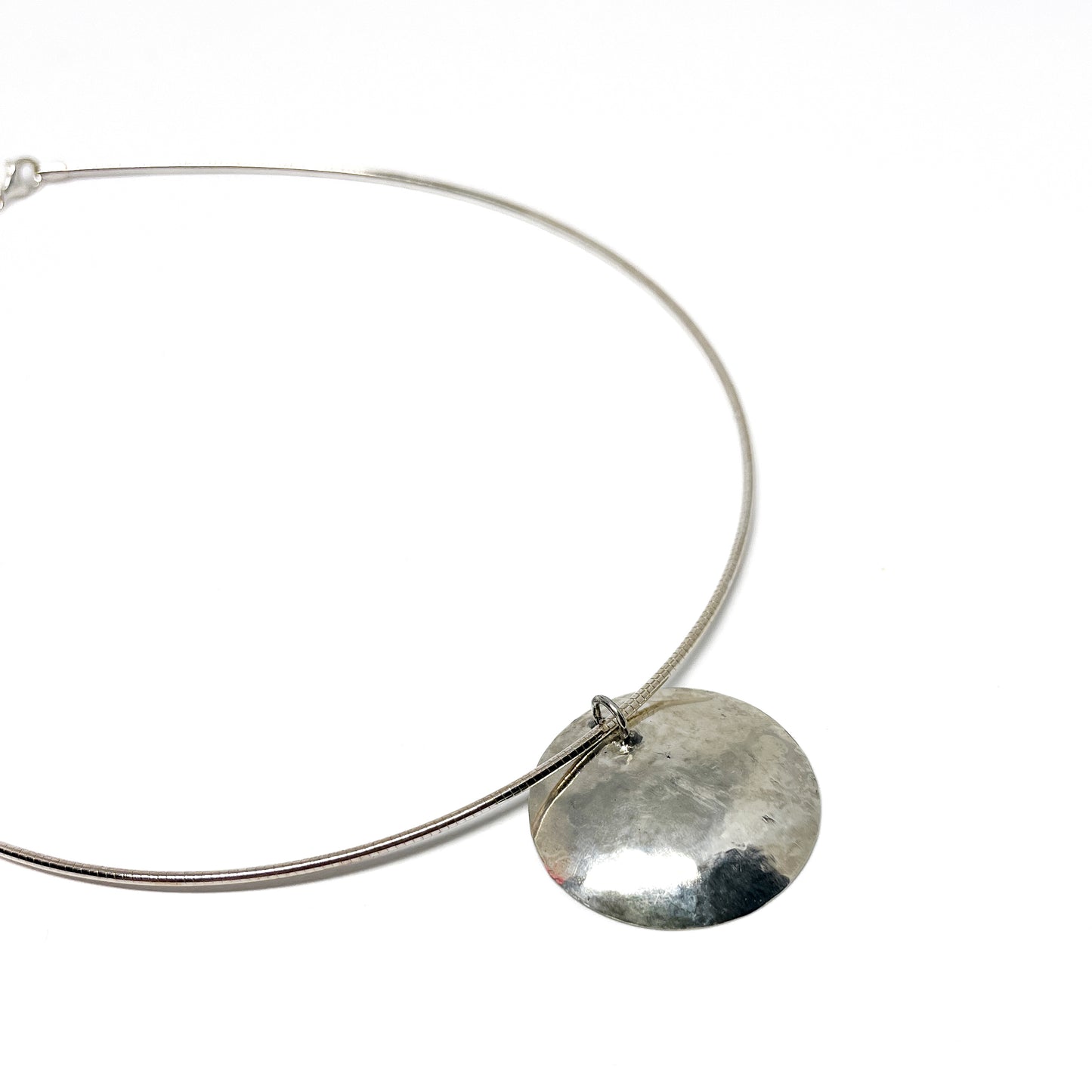 Silver Moonspace Pendant Necklace with the pendant hanging from the circular wire.