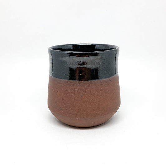 A two-toned wine cup with a brown base and black rim.