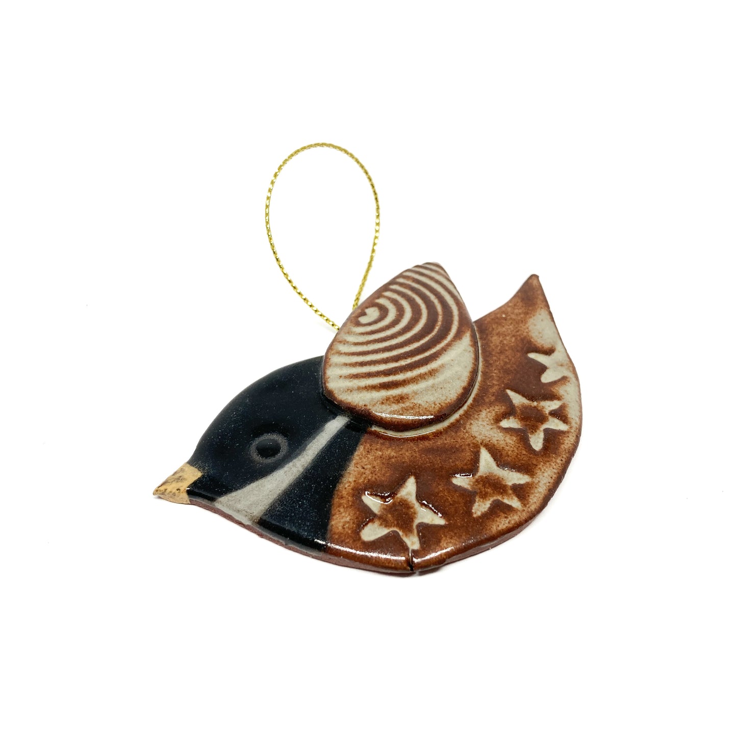 One brown bird ornaments with floral and striped wing patterns and gold strings.