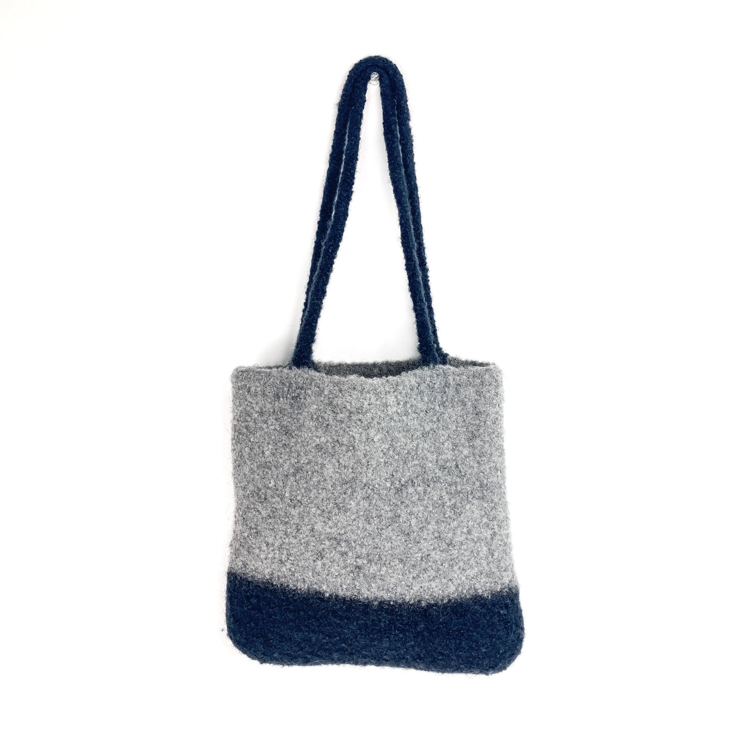 Two-tone felted tote bag with two thick, looped handles. The lower portion of the bag is a darker shade.