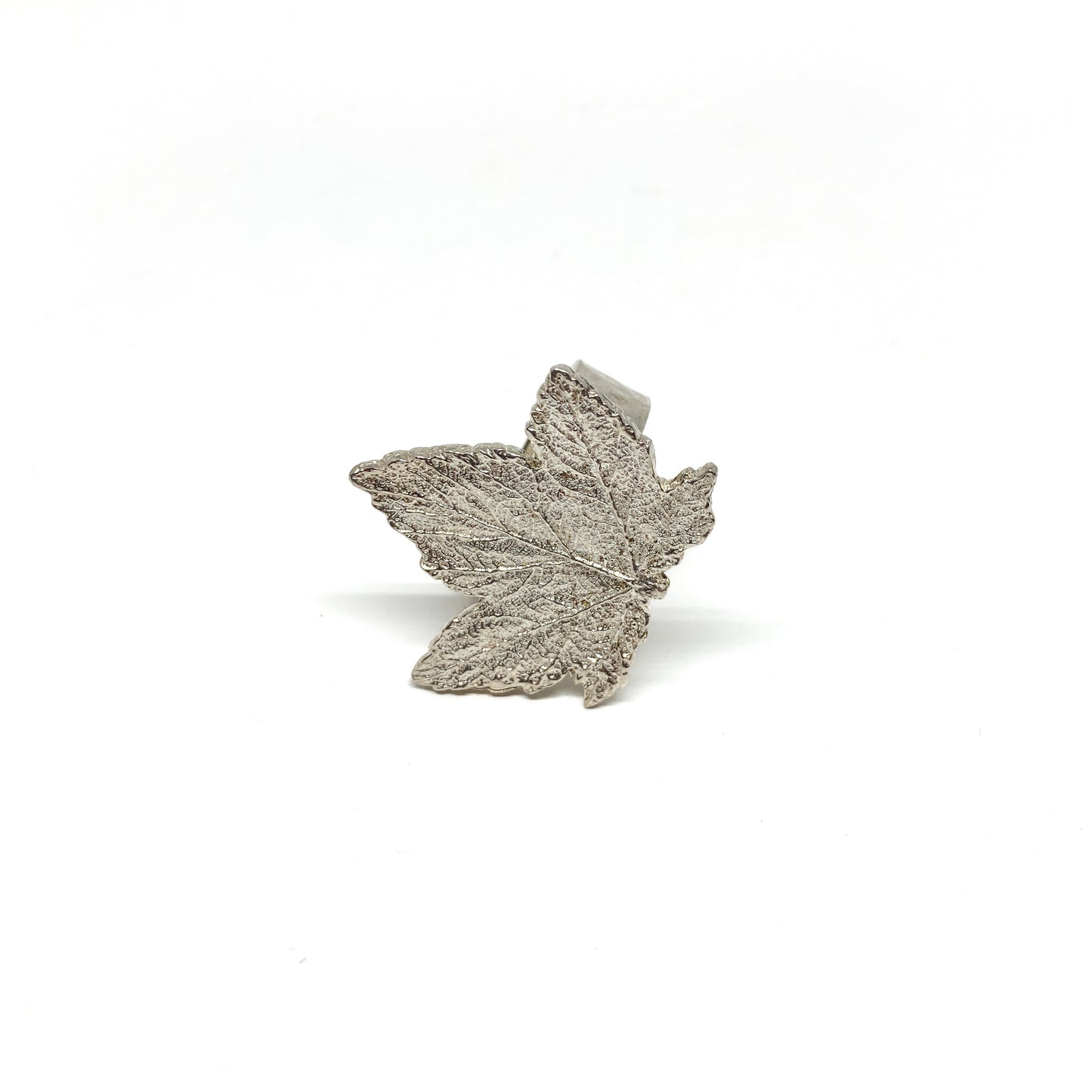 Detailed close-up of a textured silver maple leaf ring.