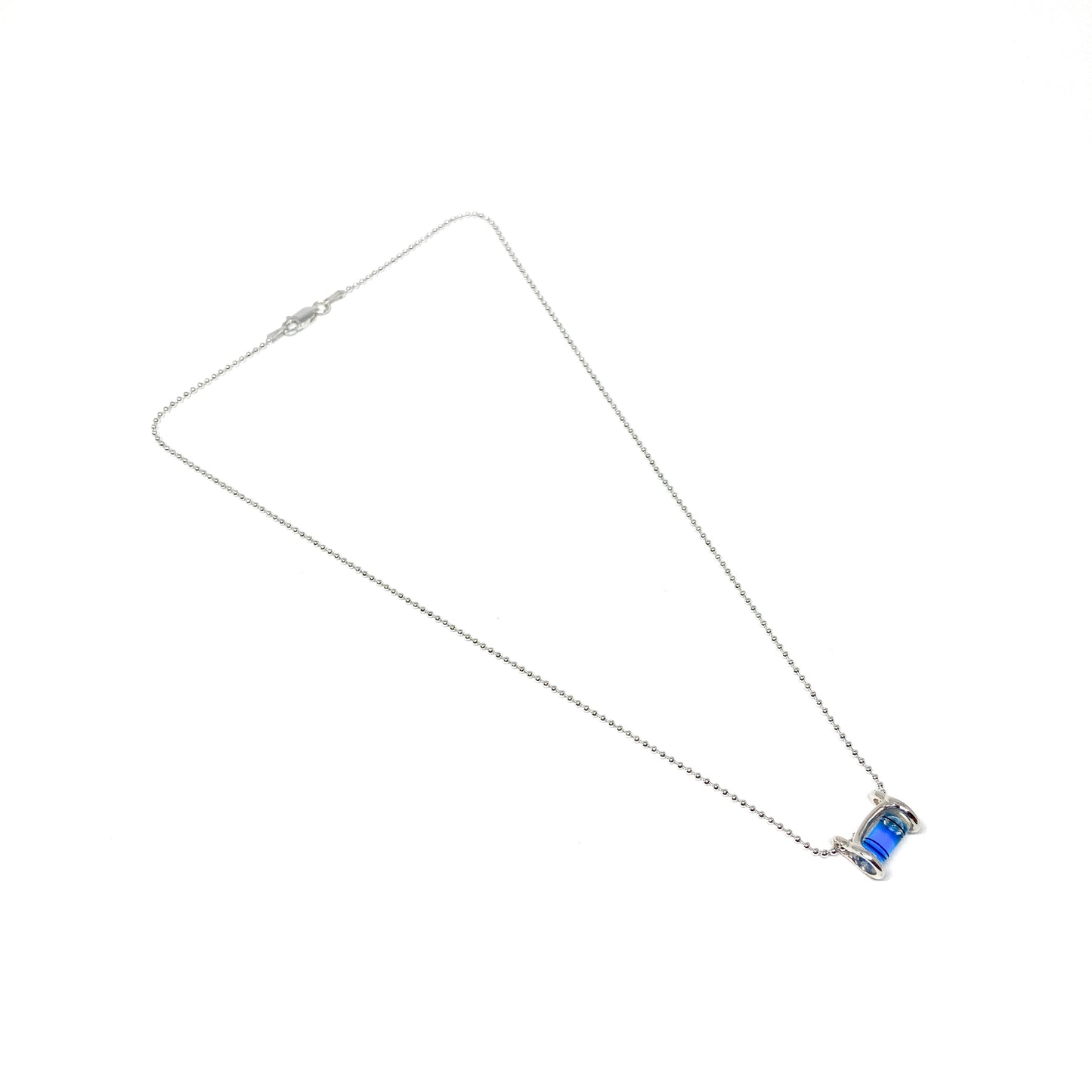 Silver necklace with a horizontal cylindrical glass pendant containing swirling bright blue pigment.