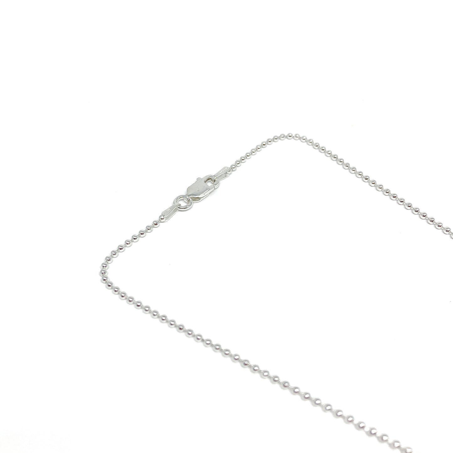 Close-up of a Sterling Silver 1.0mm Diamond Cut Ball Chain necklace with a lobster claw clasp.