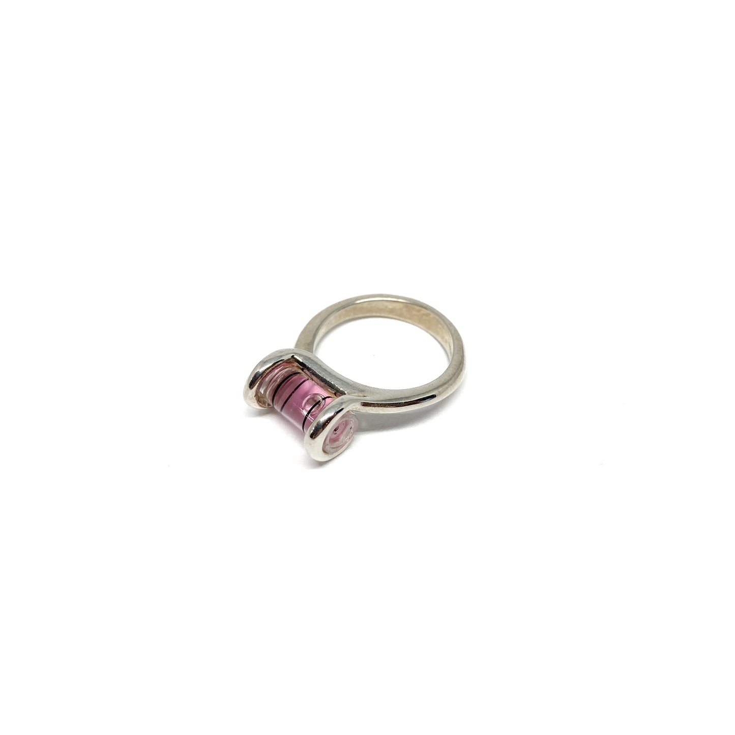 Silver ring featuring a miniature bubble level with pink liquid and a centered clear bubble.