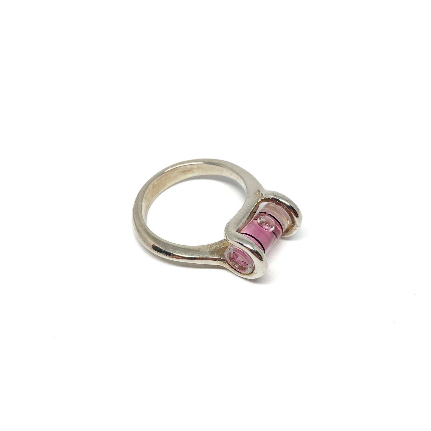 Silver ring featuring a miniature level with pink liquid and a clear bubble slightly off-center.