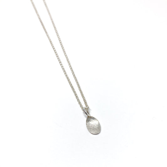 Silver necklace, angled on white.