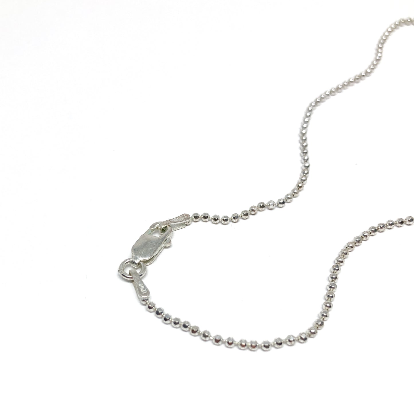 Silver ball chain necklace, close-up with clasp detail.