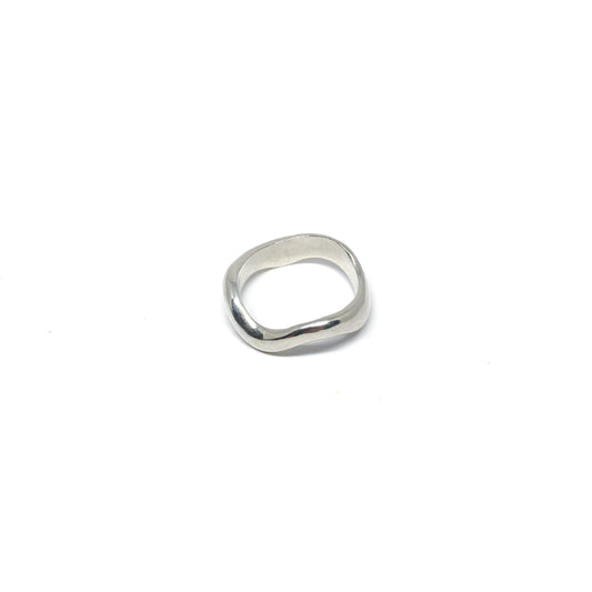 Modern silver ring with a fluid, sculptural design.