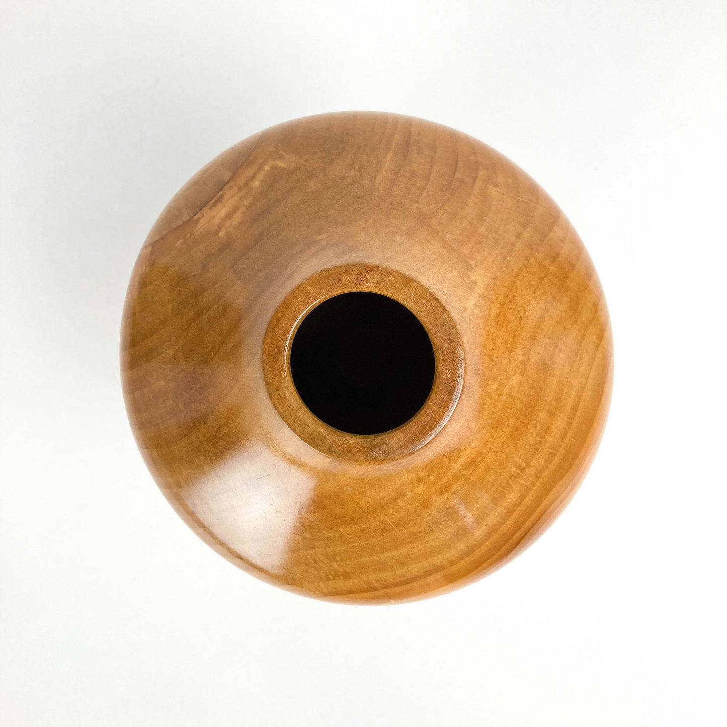 Top-down view of a wooden Alder Hollowform vase showing its circular opening.