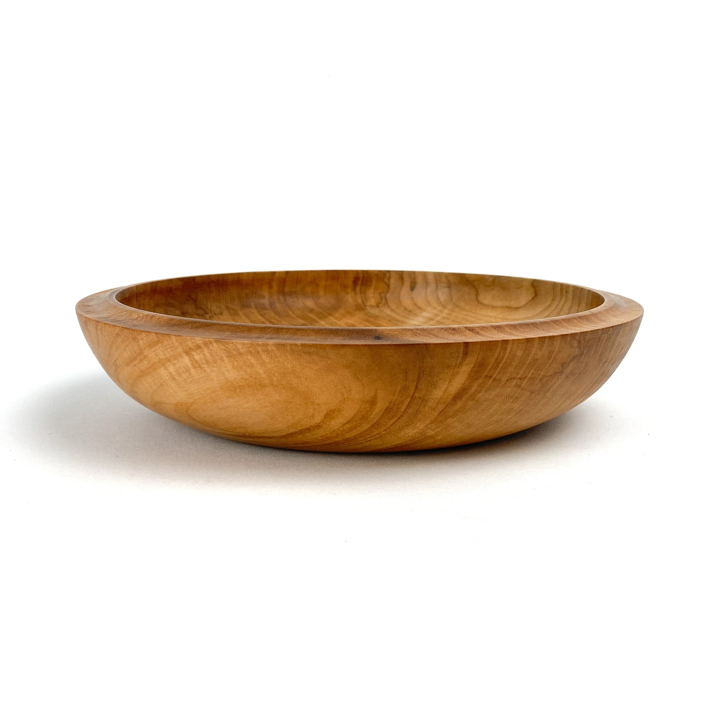 Hand-turned maple bowl with a smooth, rounded shape and visible wood grain.