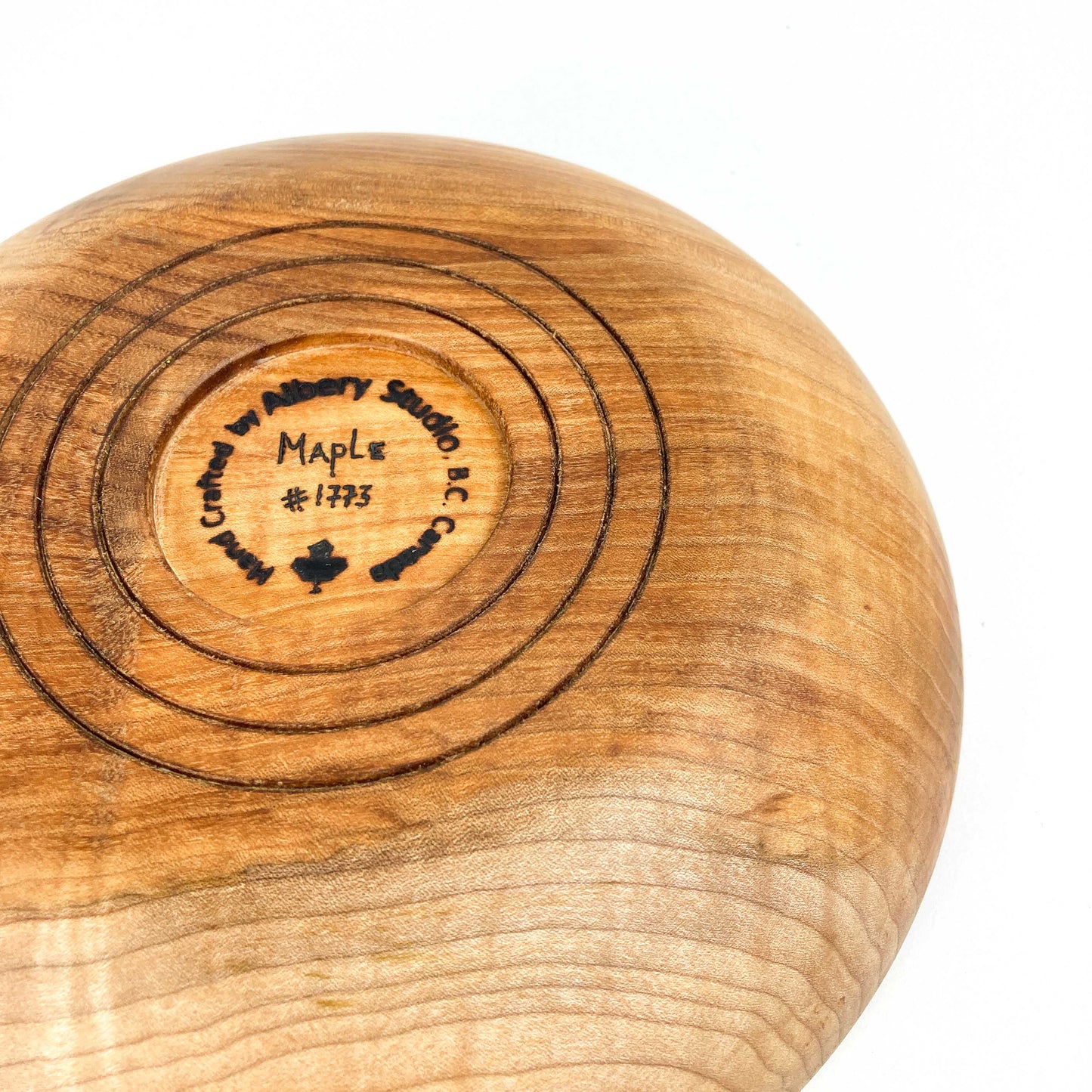 Underside of a maple bowl with a maker's mark indicating "Maple #1773" and "Crafted by Alisary Studio B.C. Canada".
