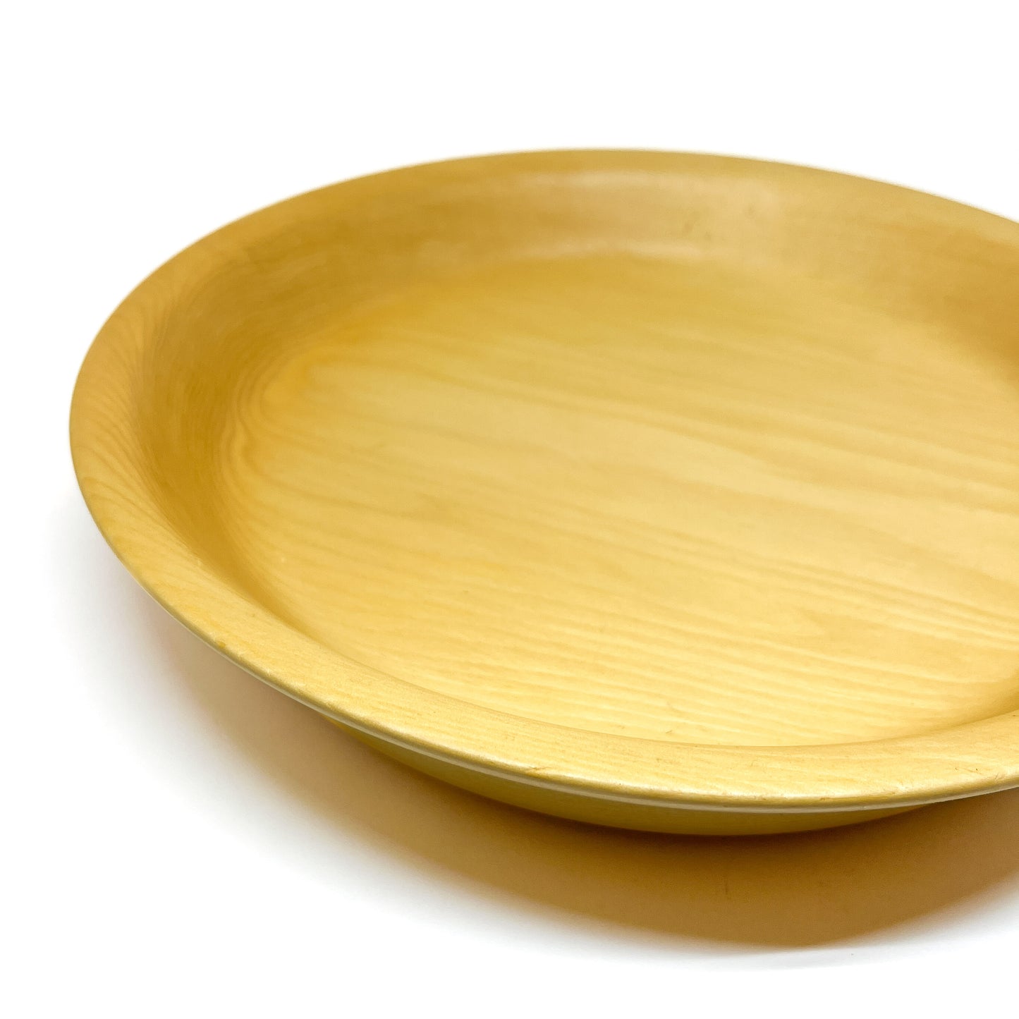 A close-up, angled view of a yellow cedar serving tray.