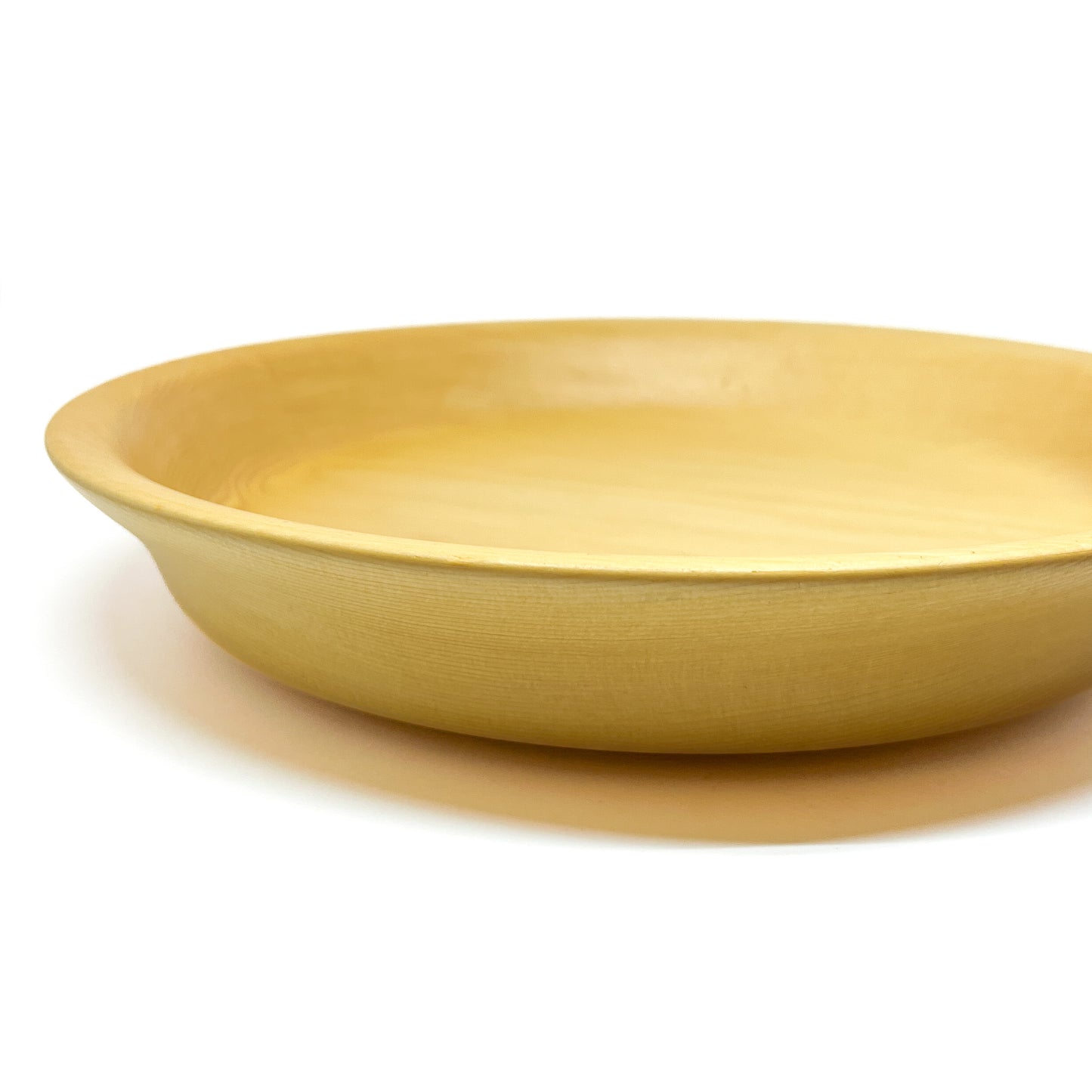 A side view of a yellow cedar serving tray.