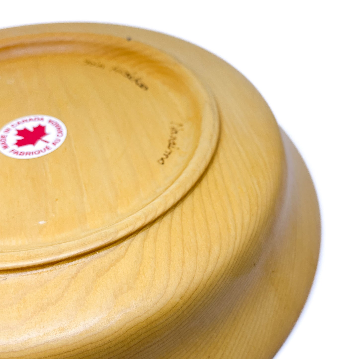 The underside of a yellow cedar serving tray, showing markings.