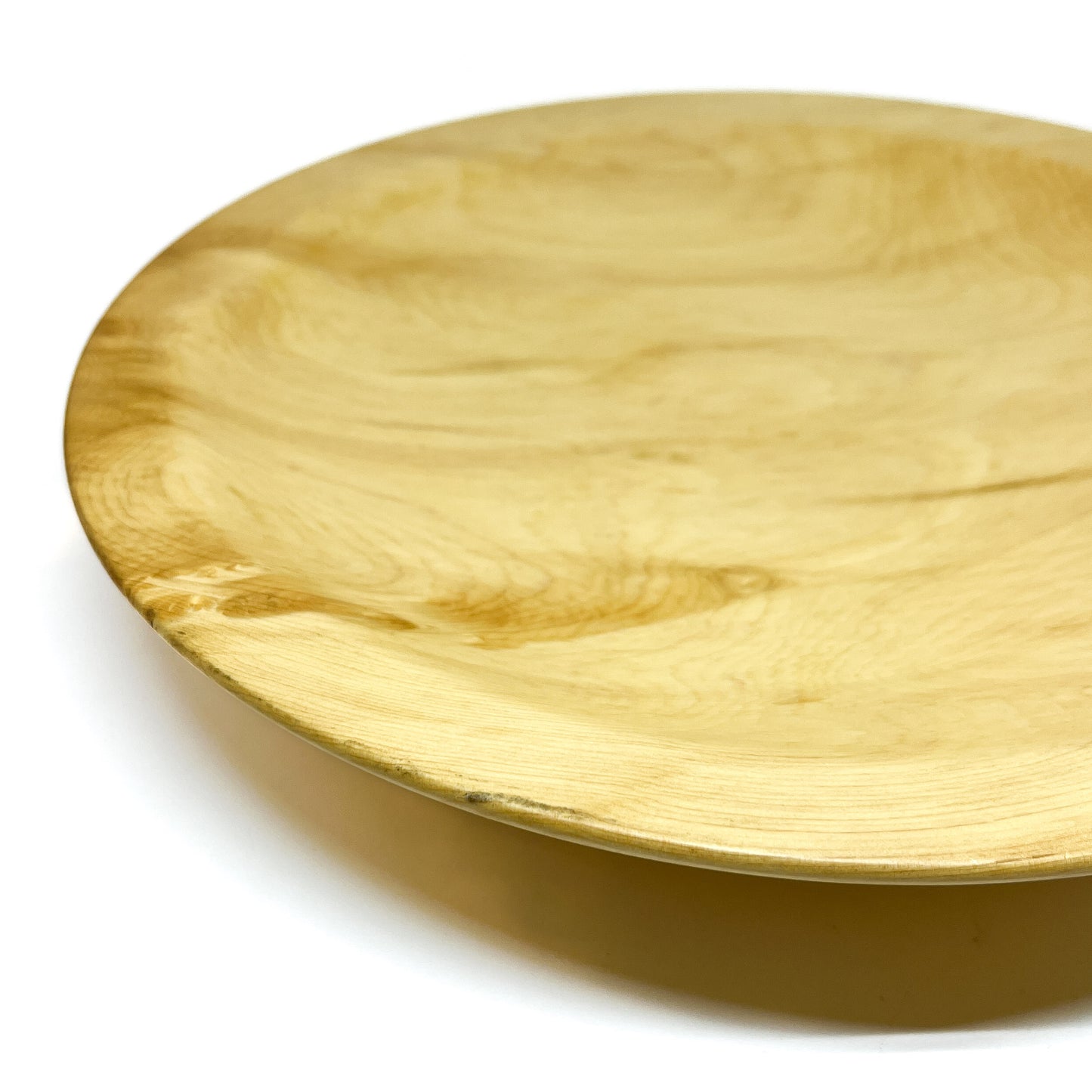 Close-up of a Yellow Cedar Platter, showing its natural wood grain and subtle curvature.