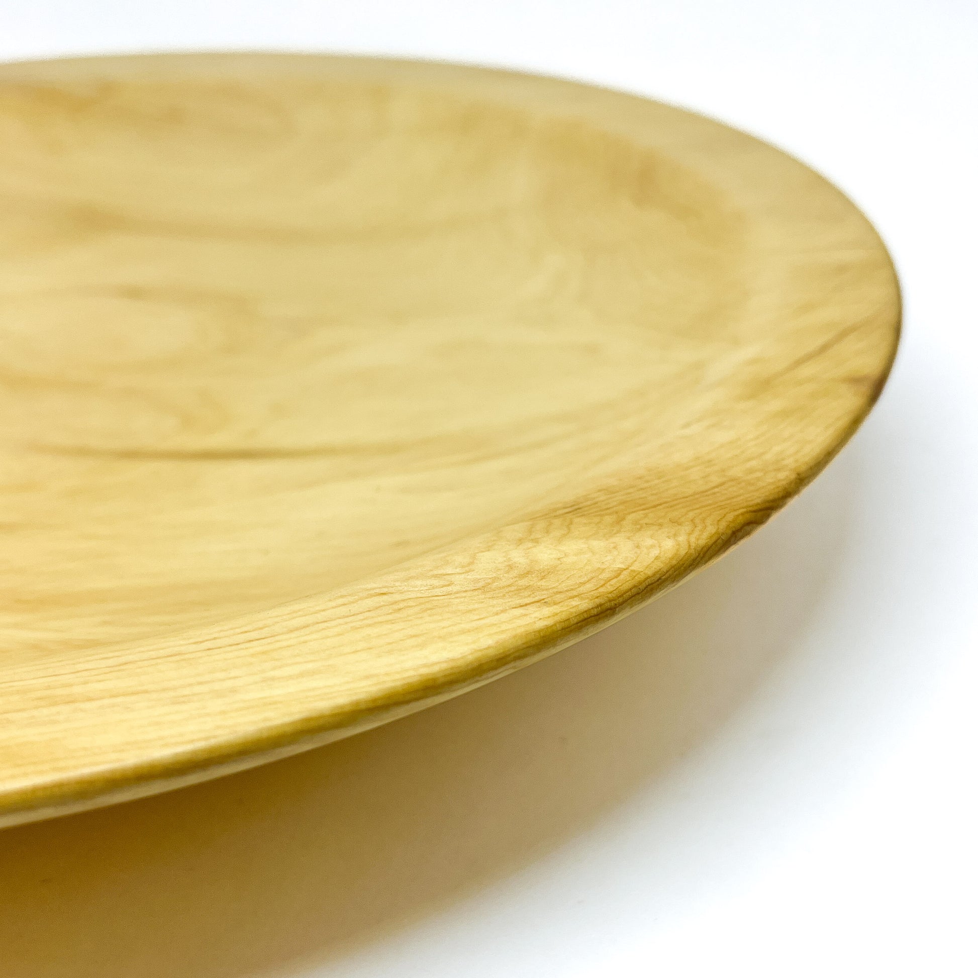 Detailed view of the rim and surface texture of a Yellow Cedar Platter.
