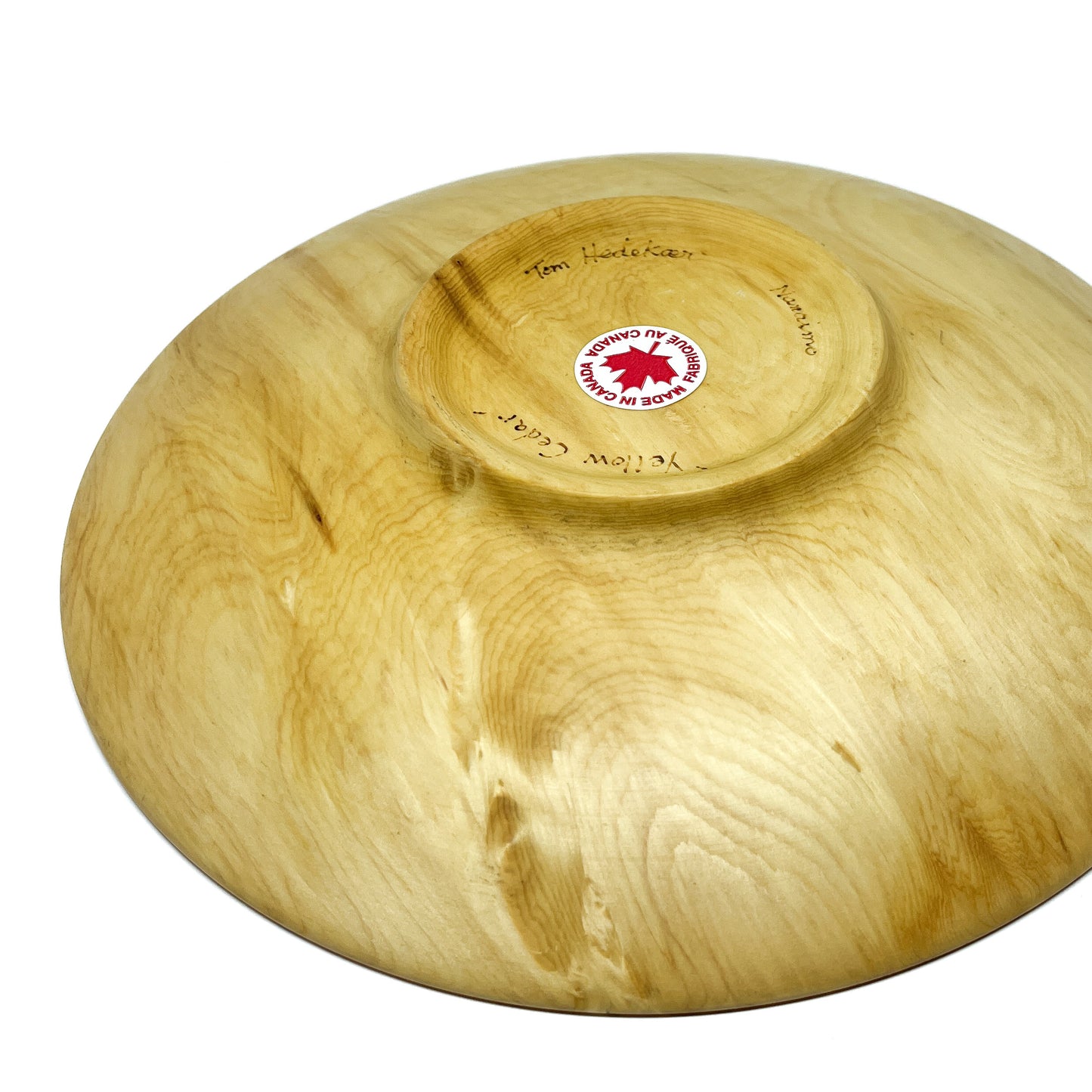 Underside of a Yellow Cedar Platter, revealing its carved base and a "Made in Canada" stamp.