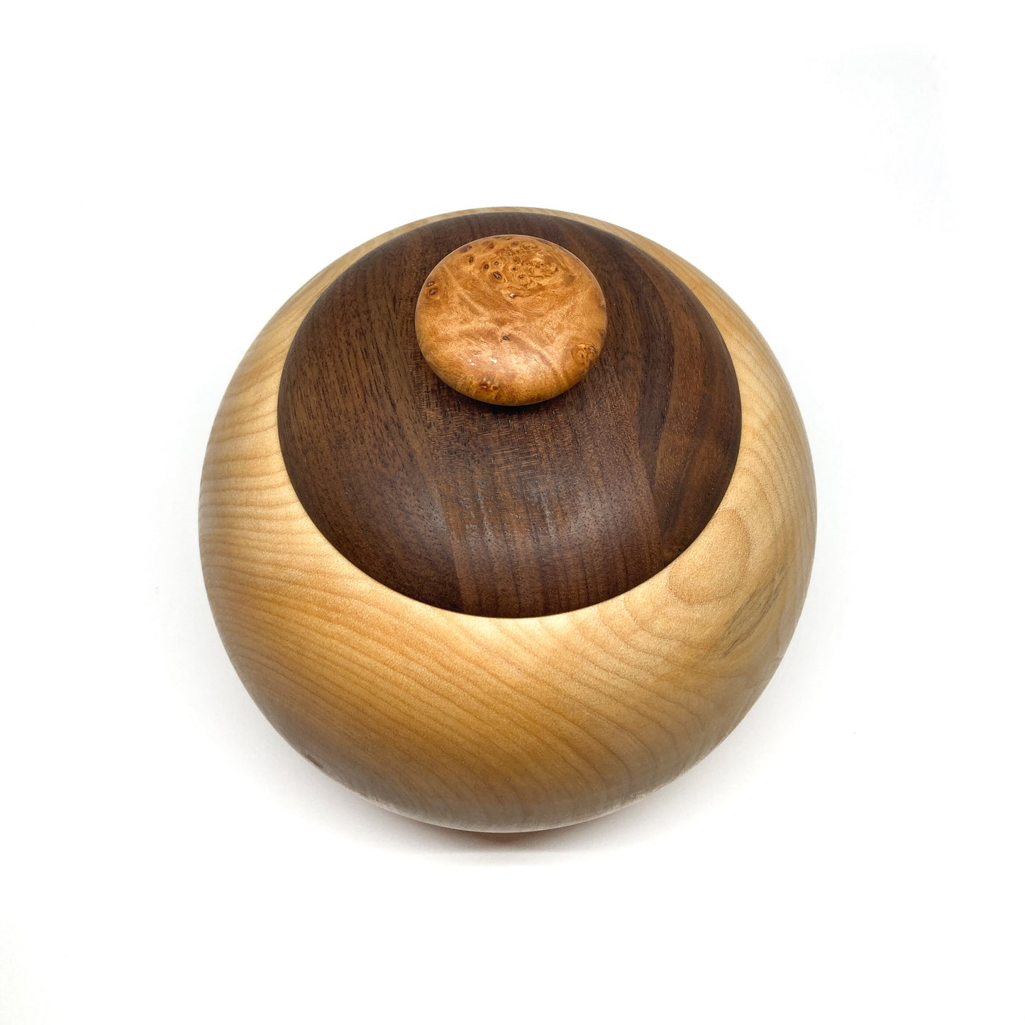 Top-down view of a lidded maple bowl with a dark walnut lid and a unique, burled wood knob.