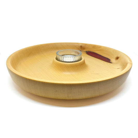 A yellow cedar candle tray with a glass votive holder in the center and a red epoxy highlight.