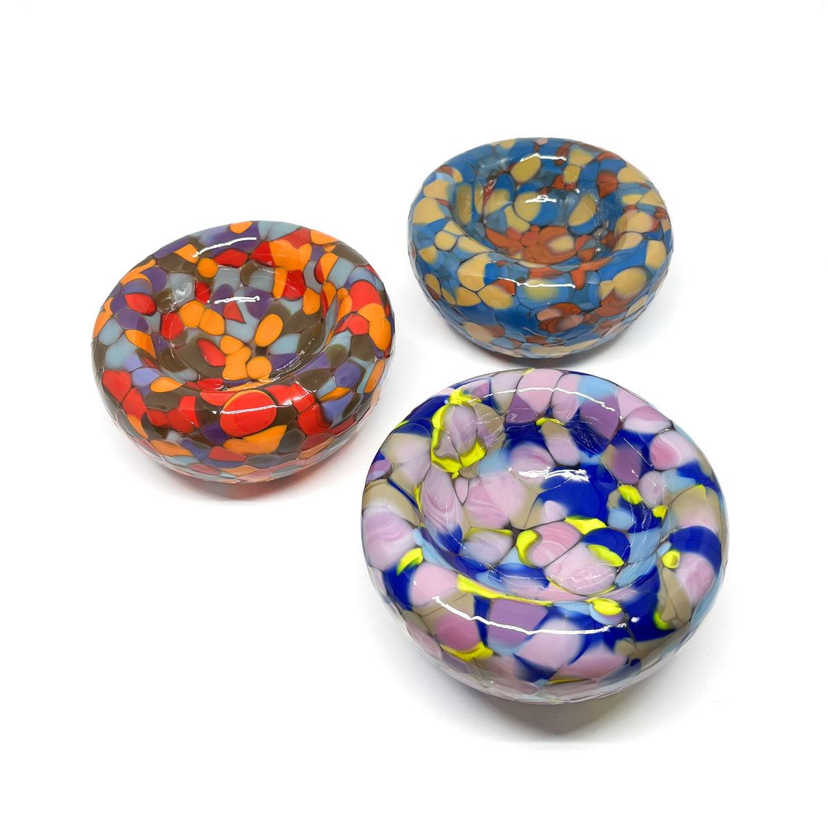 Trio of Blotched Nest Bowls with speckled, multicolored designs in a rounded, glossy form.