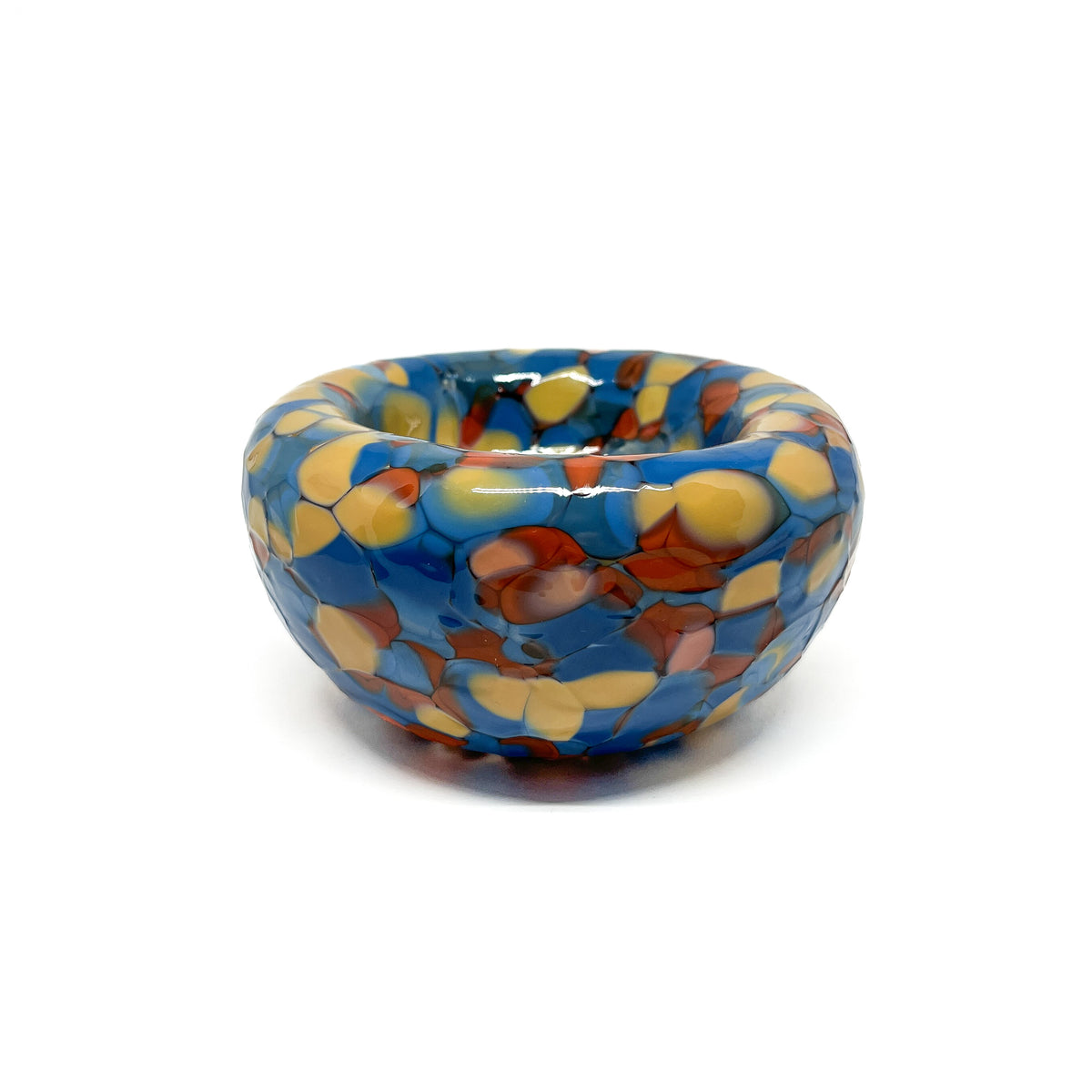 Side view of a blue-orange Blotched Nest Bowl showcasing its smooth rim and dotted pattern.