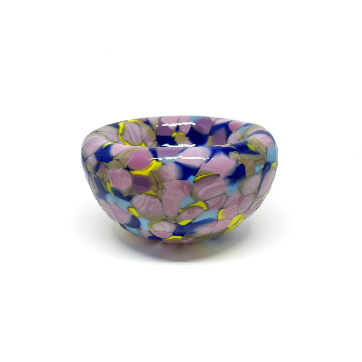 Side view of the purple-yellow Blotched Nest Bowl featuring rounded form and vivid details.